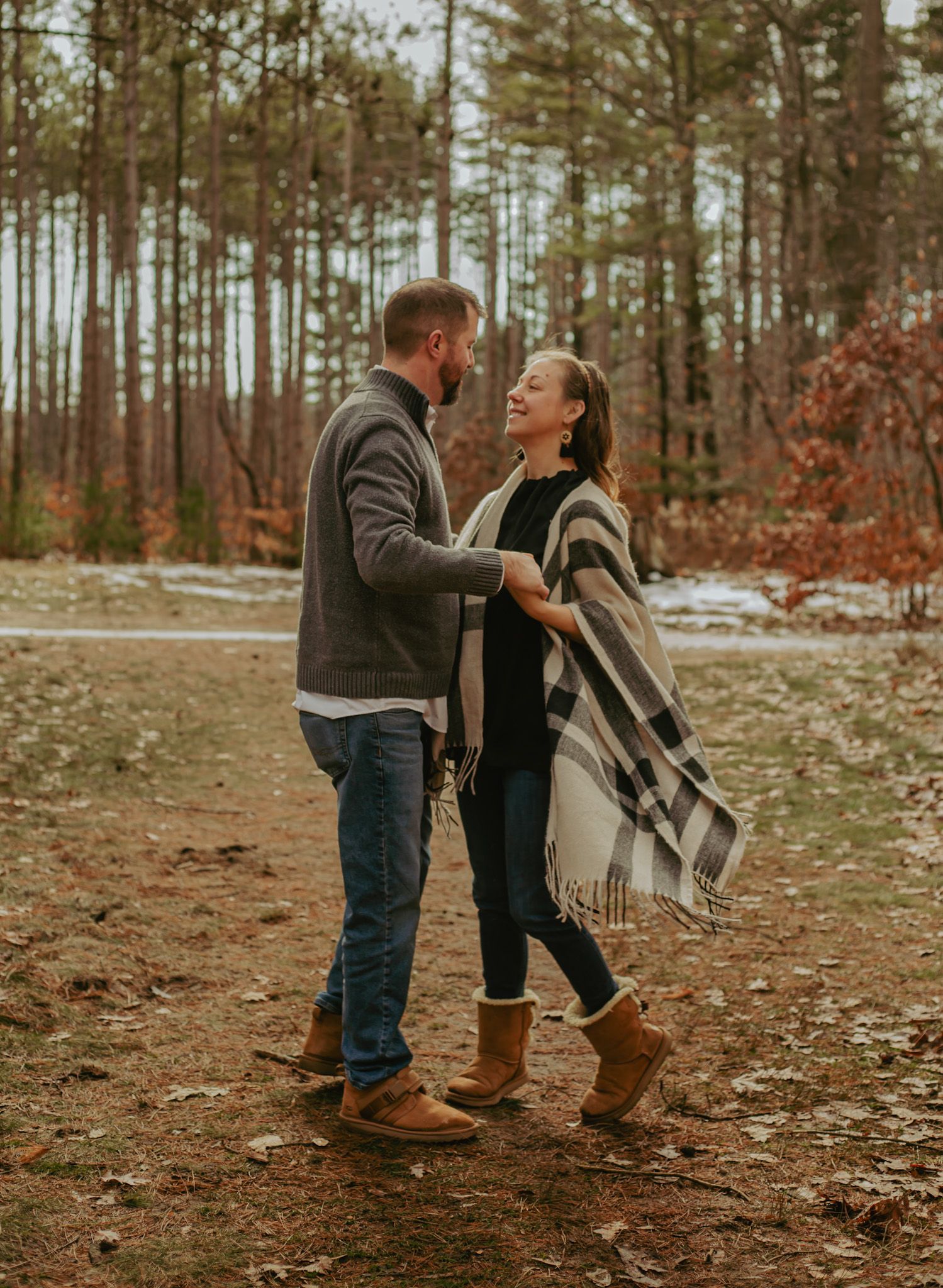 Candid family interactions captured in autumn forest setting.