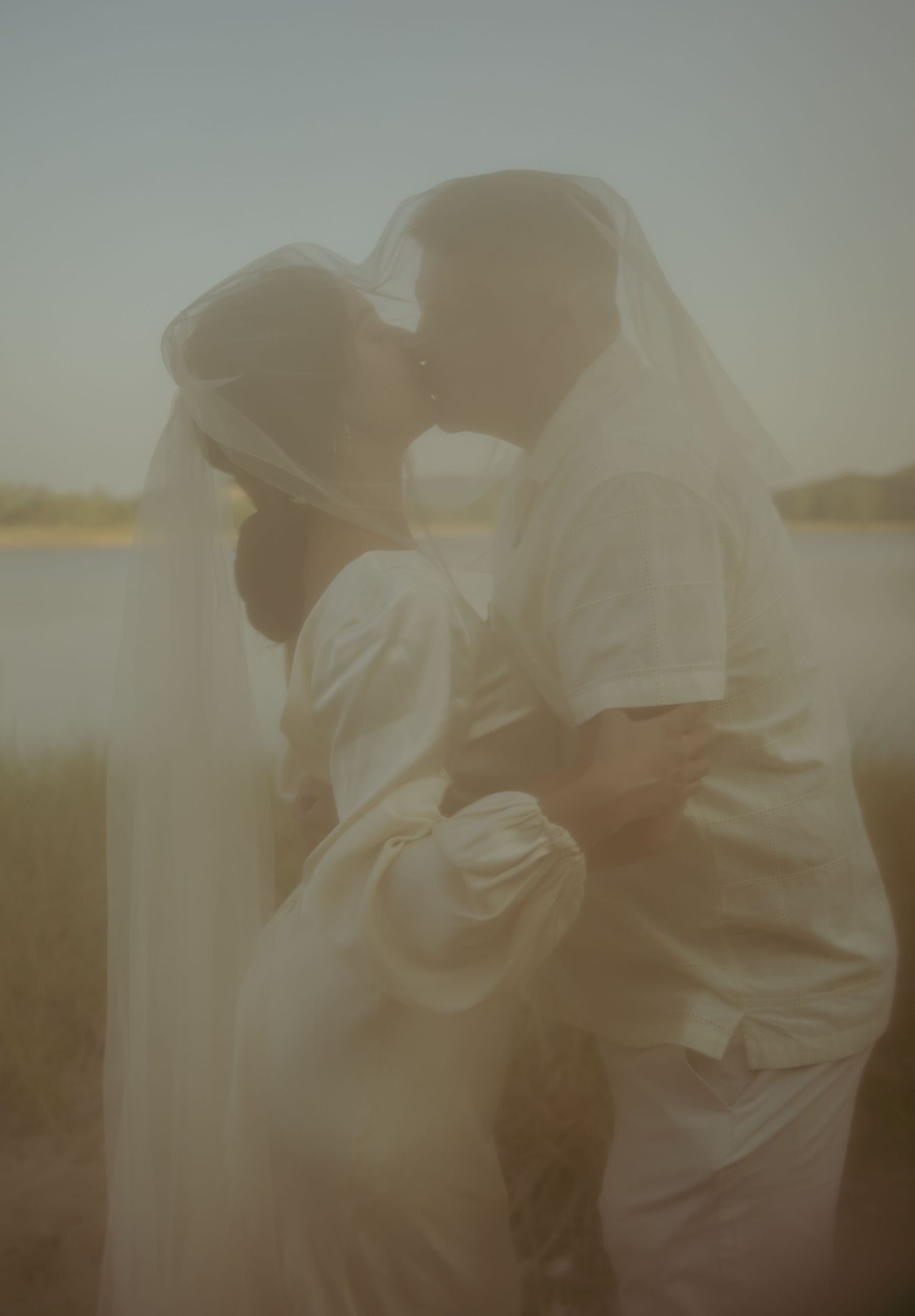Ethereal and dreamy sequence of figures embracing in soft golden light.