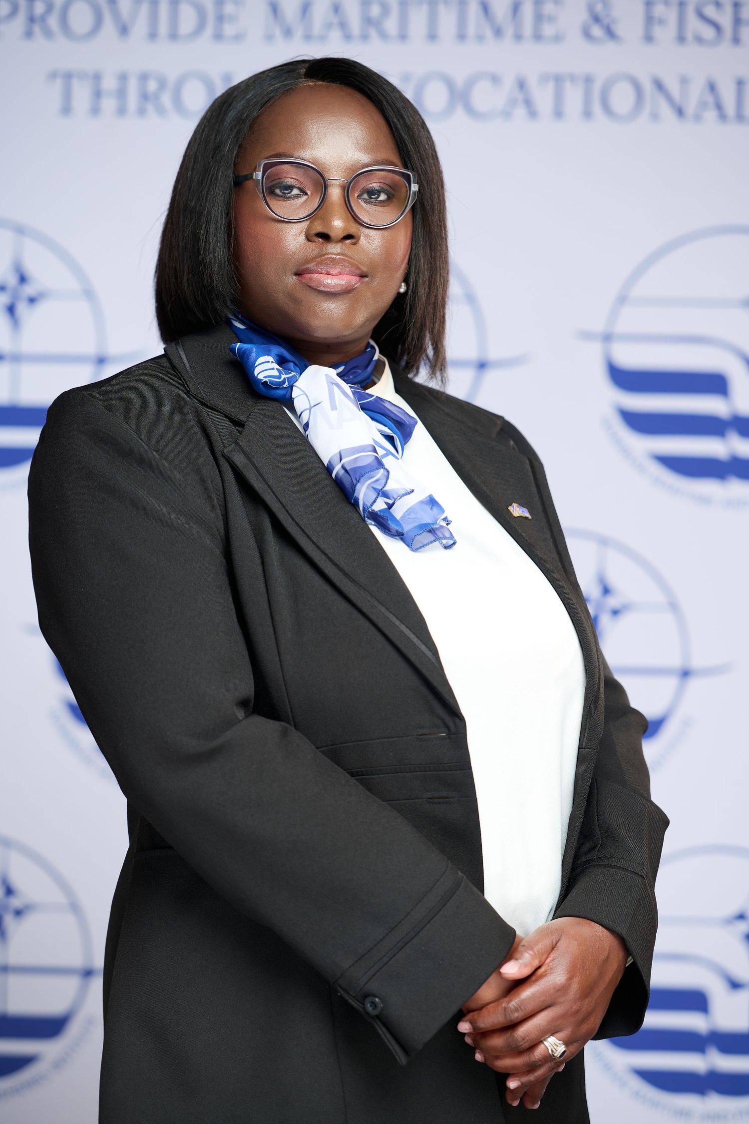 Professional wearing a black blazer and glasses poses confidently against a light blue and white background with text.