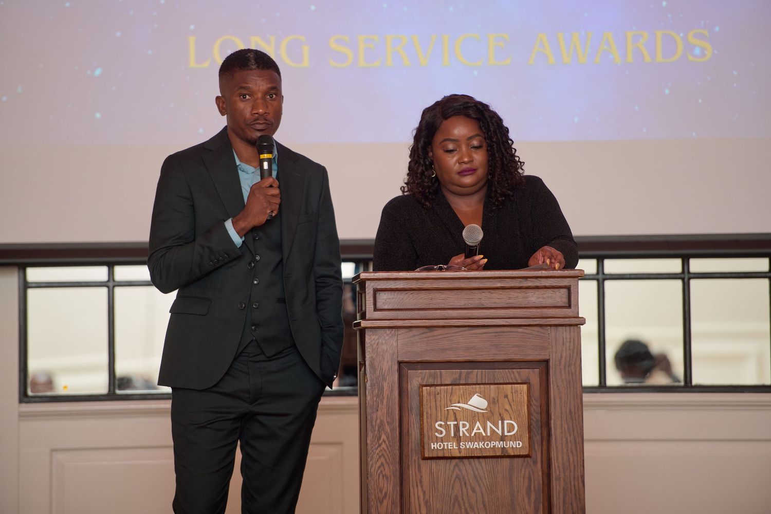 Namibia Fish Consumption  promotion Trust Two presenters at a podium during the Long Service Awards ceremony at the Strand Hotel.