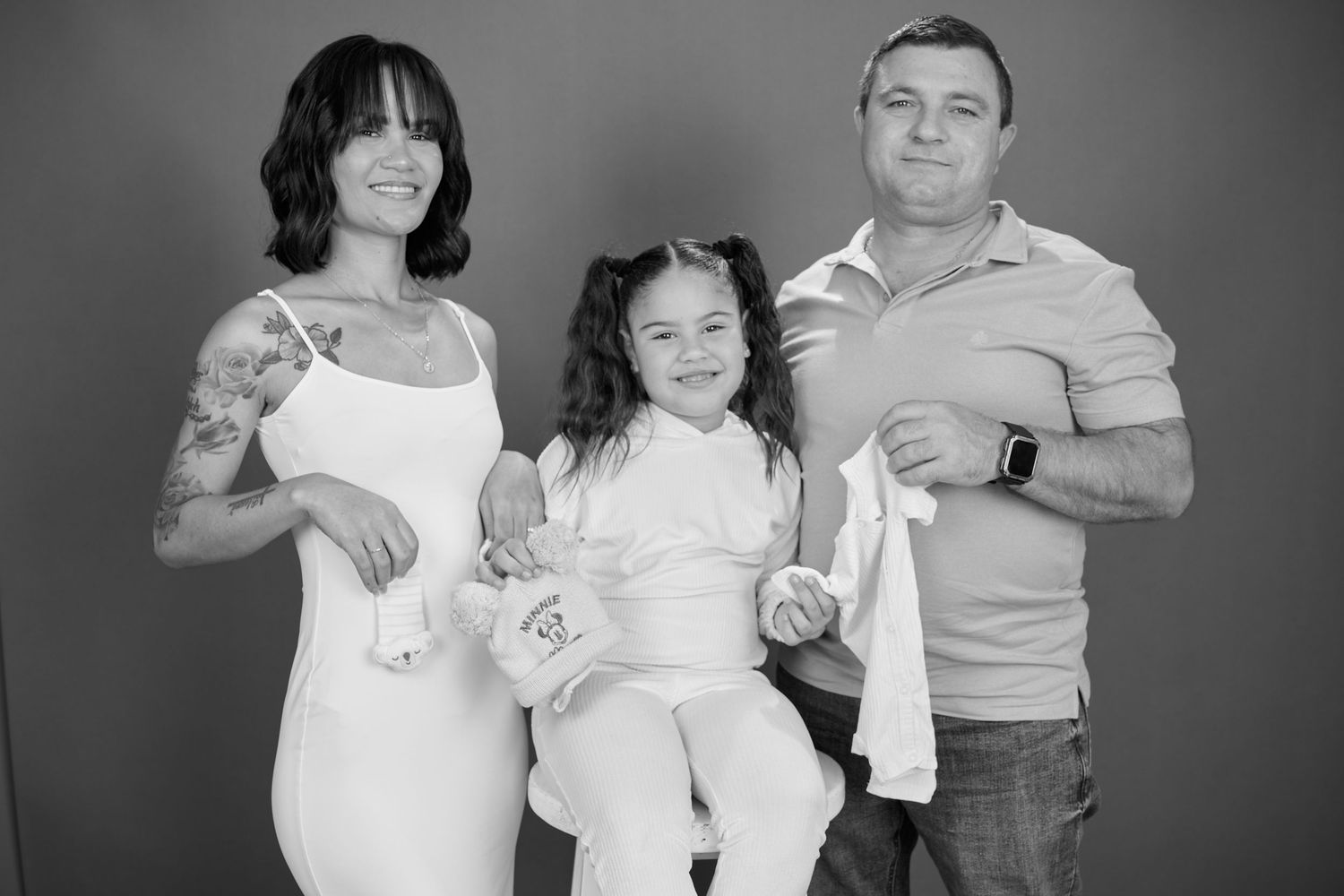 A black and white photo series showing the progression of a growing family over multiple years.