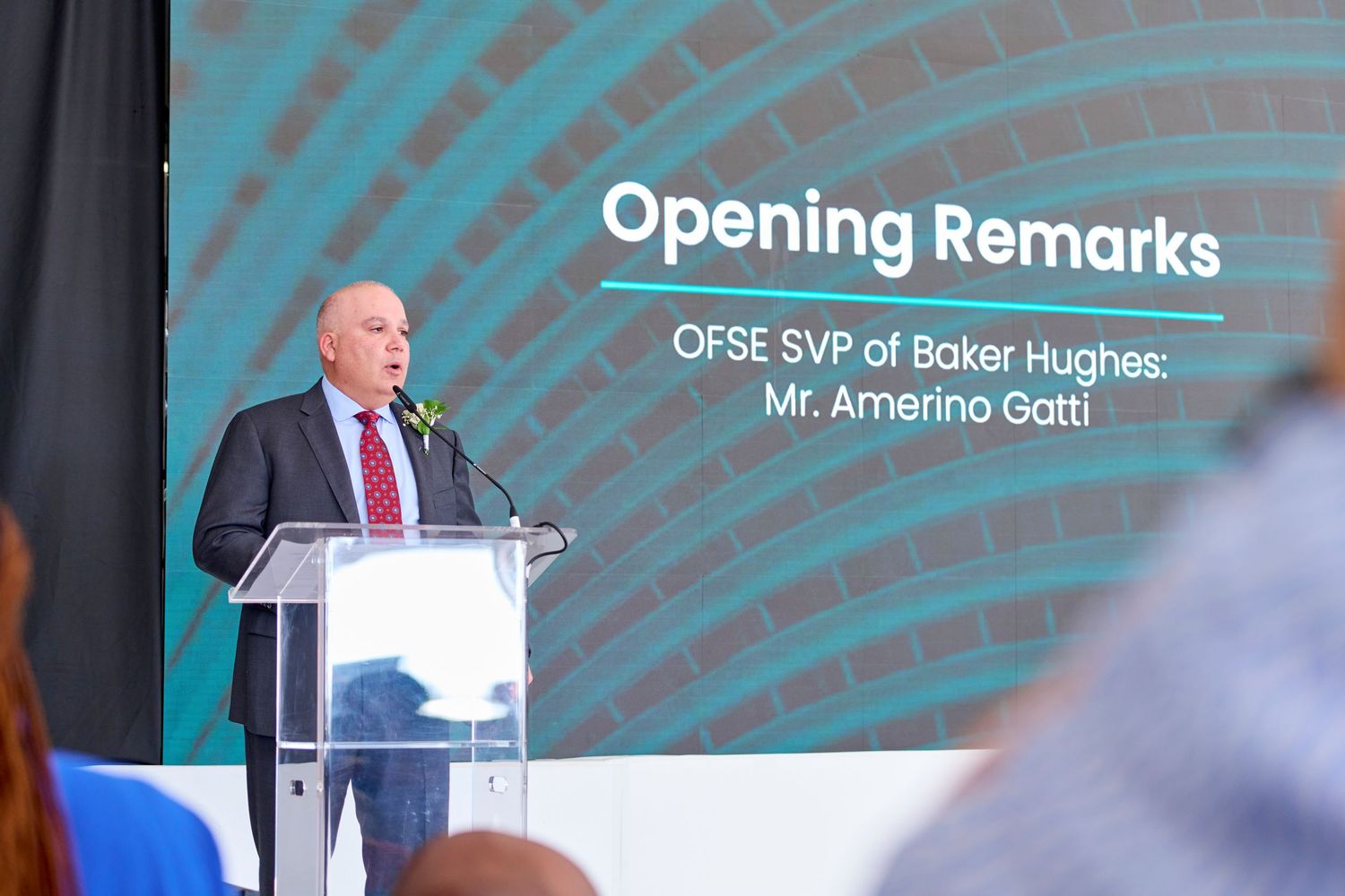 Baker Hughes OFSE SVP Amerino Gatti delivers opening remarks at podium during corporate event.