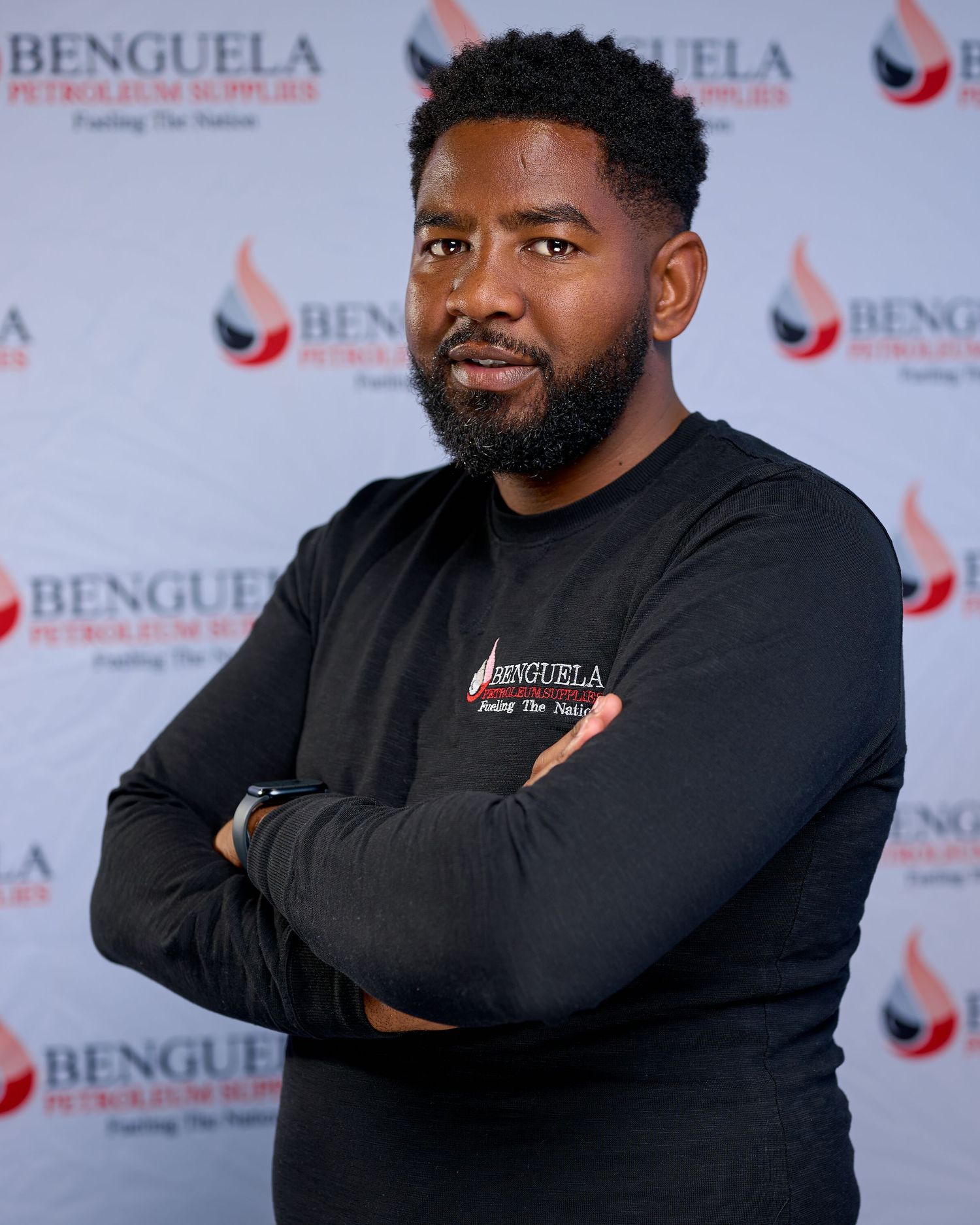 Professional headshot photos of a person wearing a black shirt against a branded backdrop with Benguela logo.
