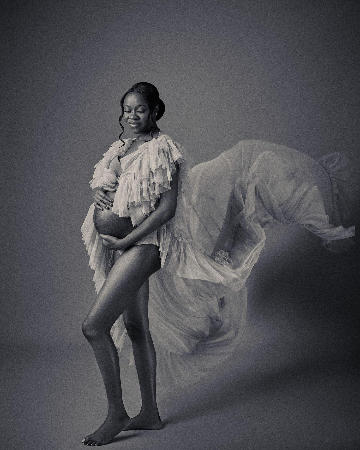 Artistic black and white dance photo series showing flowing white fabric movement against dark background.