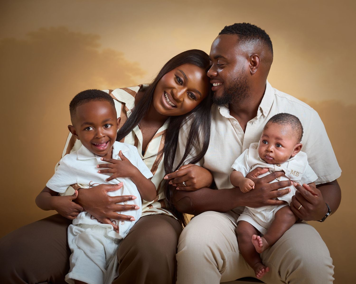 A series of warm-toned family portraits showing tender moments between parents and their baby in matching white outfits.