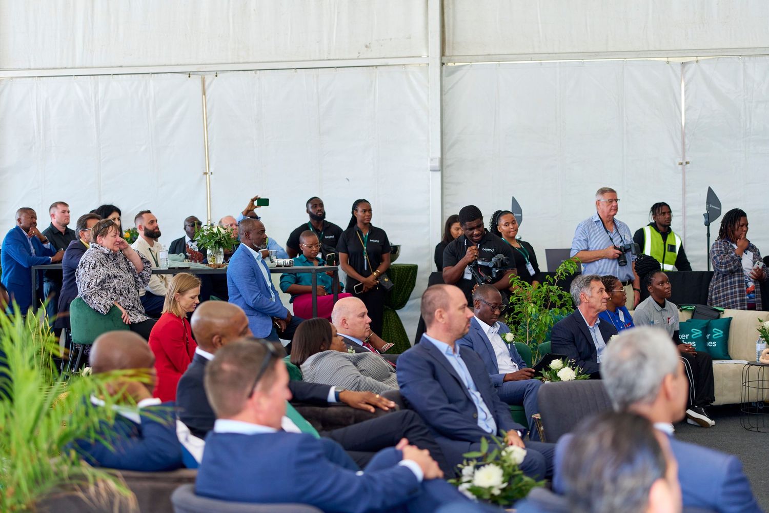 Large corporate event audience seated under white tent at Baker Hughes formal ceremony gathering.