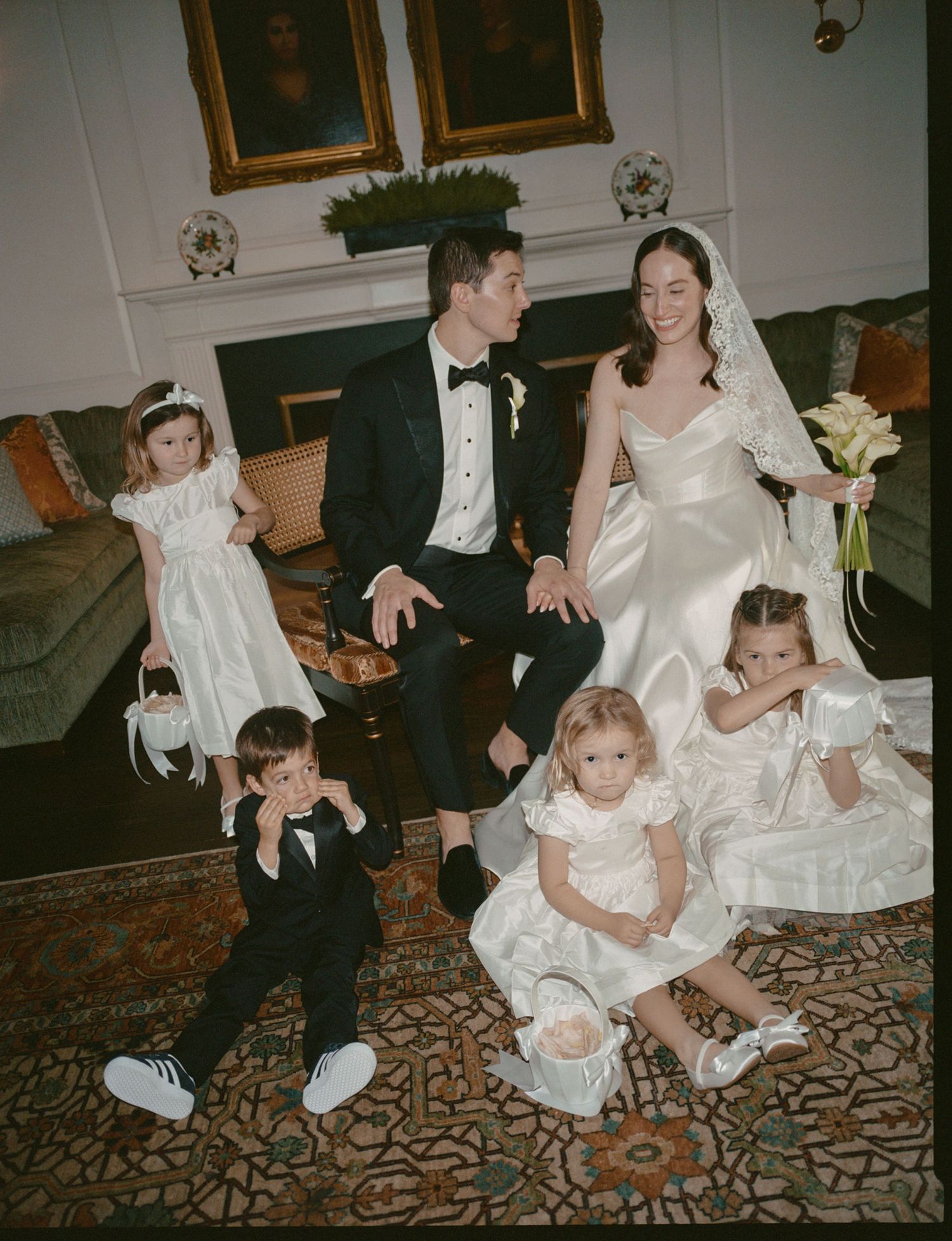 A vintage-style photo collage shows children in white formal attire playing and sitting on a patterned carpet.