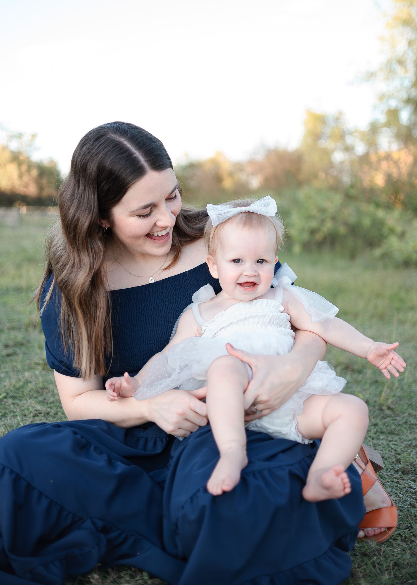 Mother holding baby during outdoor family session at Salado Creek in Salado Texas