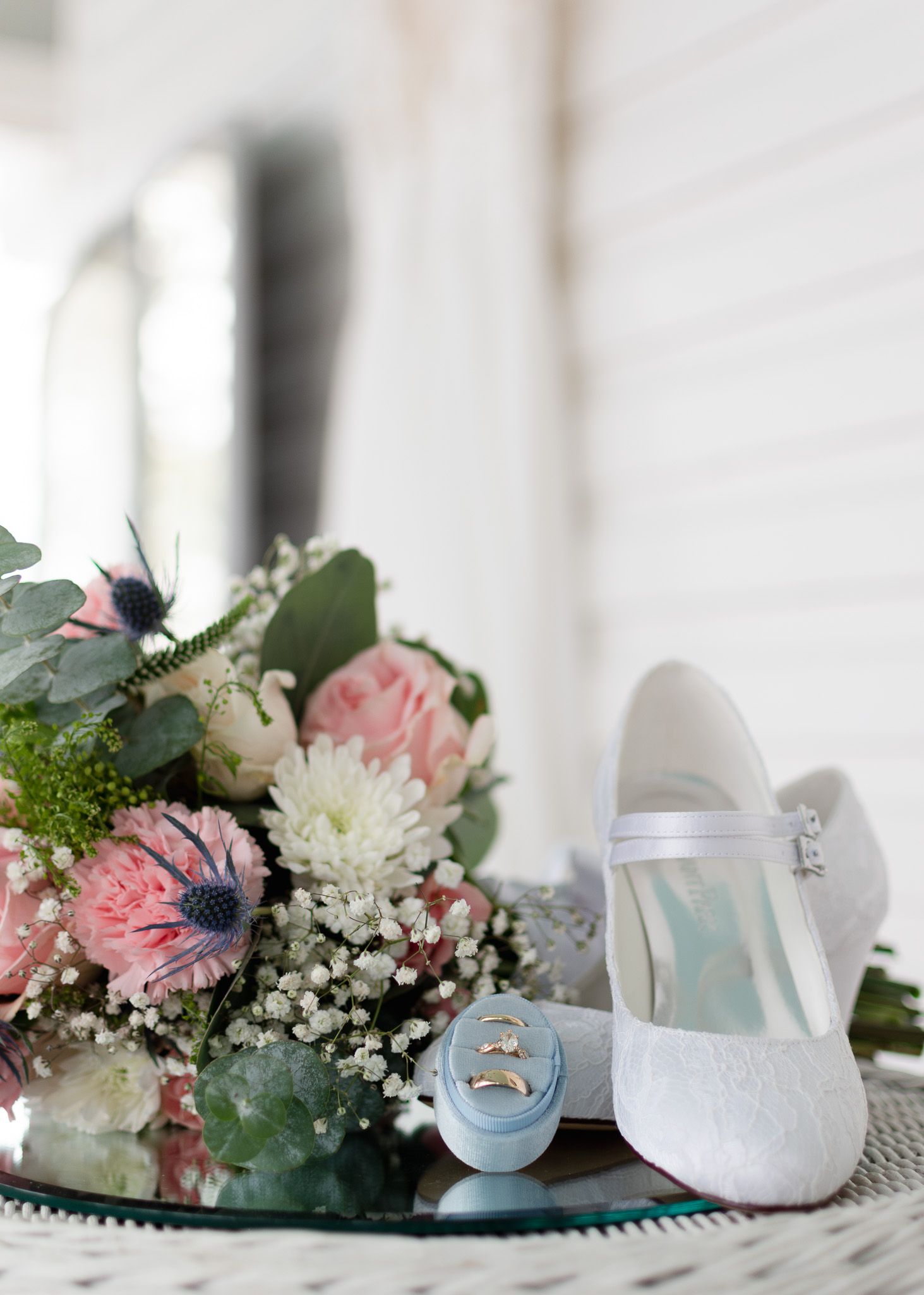 Wedding details with dress, bouquet, shoes, and rings at Winfield Inn in Dripping Springs Texas