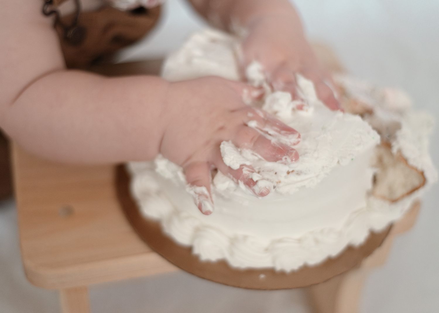 One year old boy smashing cake during milestone session with a Harker Heights Texas baby photographer.