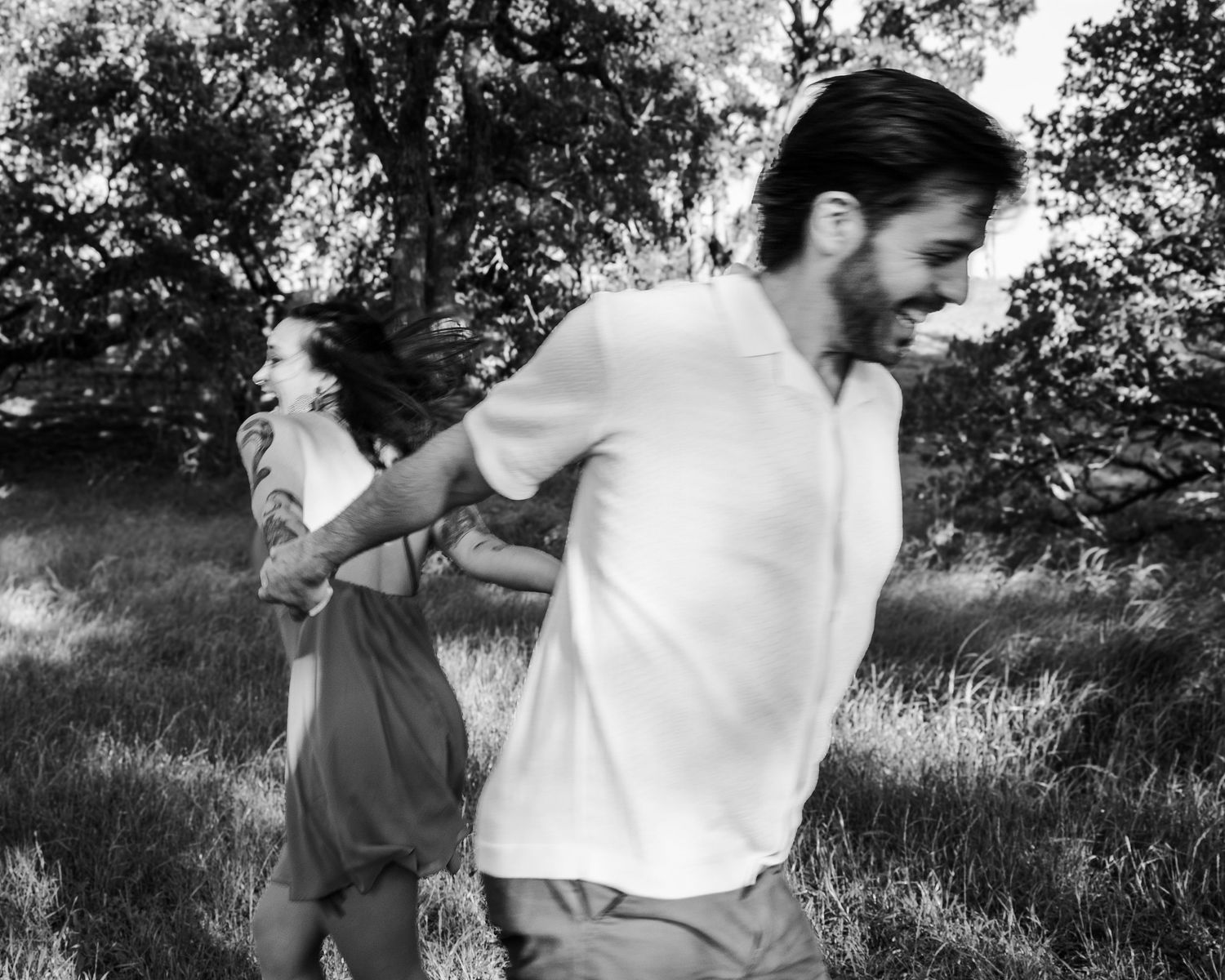 Couple spinning together during outdoor session with a Belton Texas family photographer