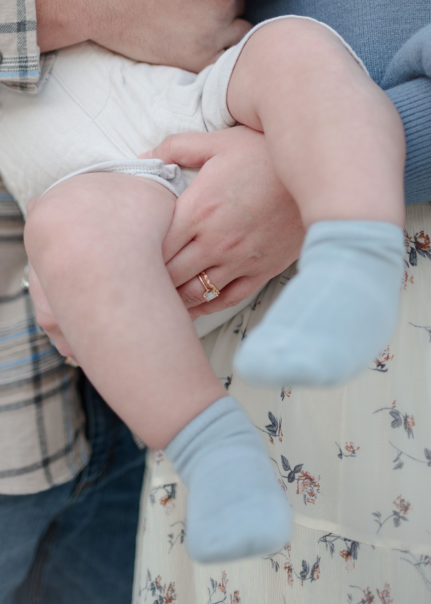 Parents holding baby during outdoor family session at Nolan Creek in Belton Texas