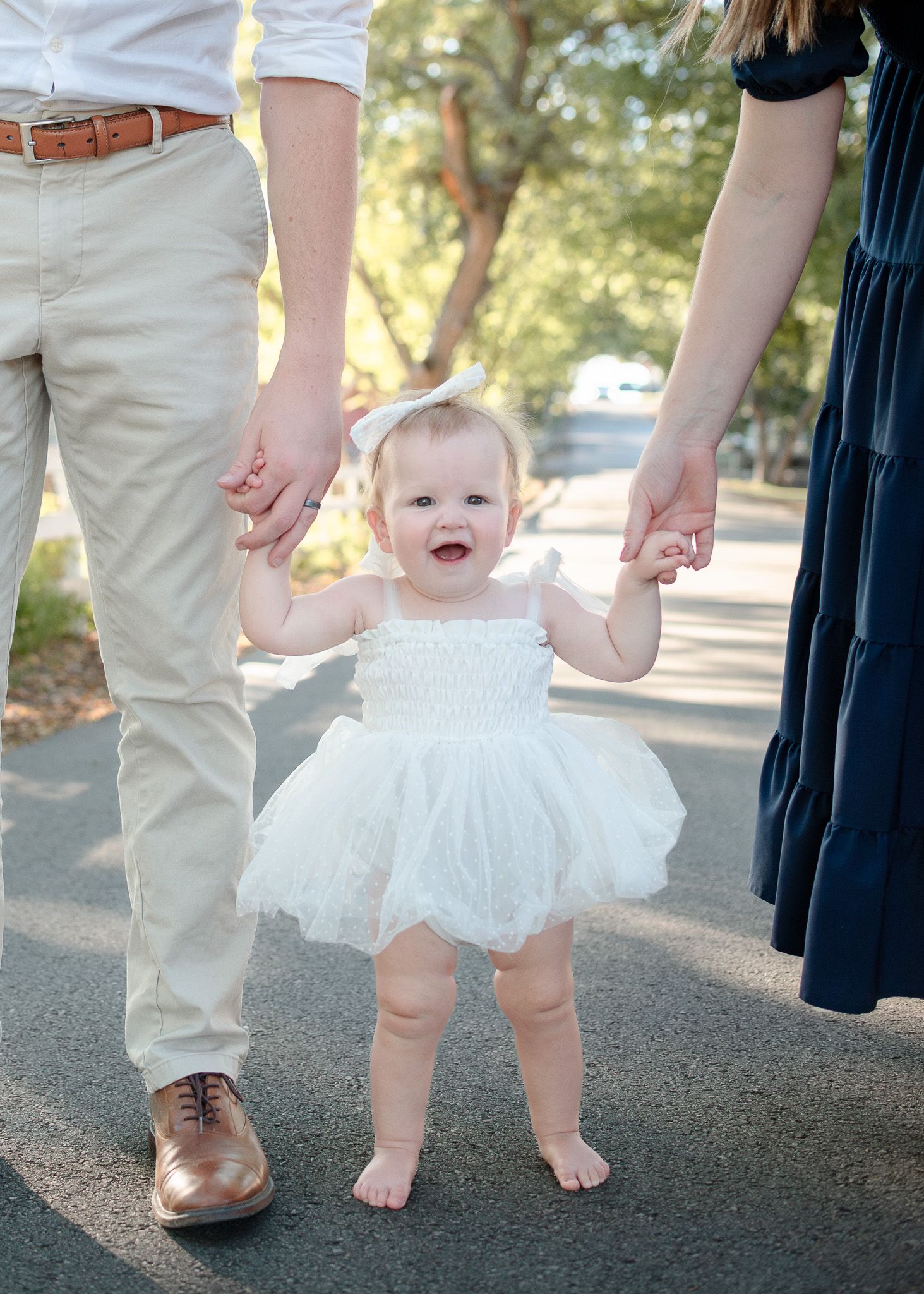 Parents holding toddler’s hands during session at Pace Park in Salado Texas