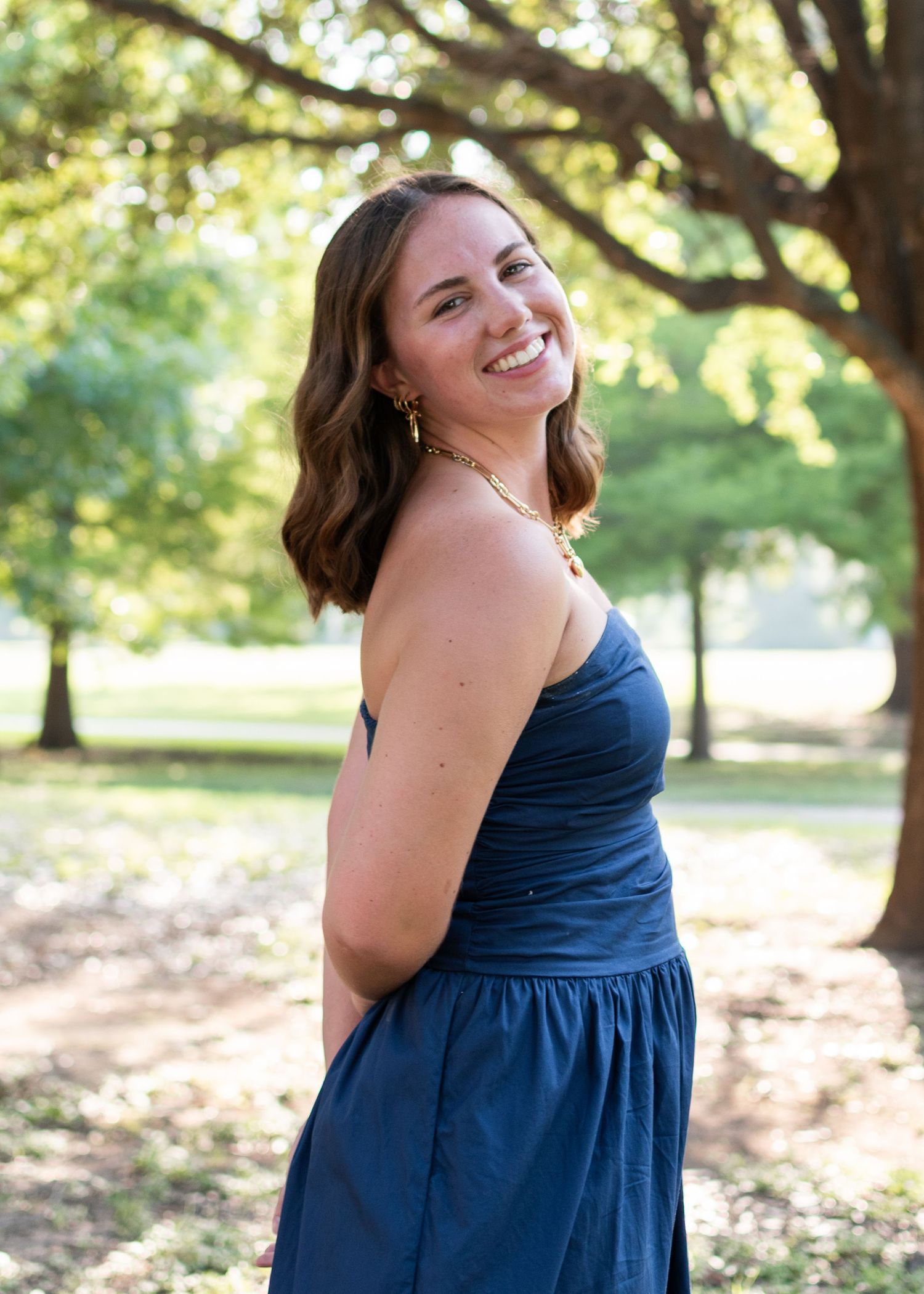 High school senior smiling during outdoor session at Butler Park in Austin Texas