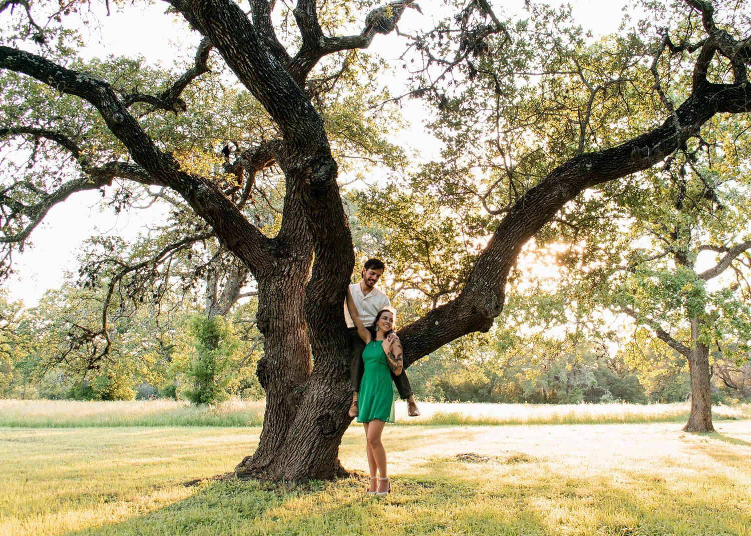 Couple standing under large oak tree during session with a Central Texas family photographer
