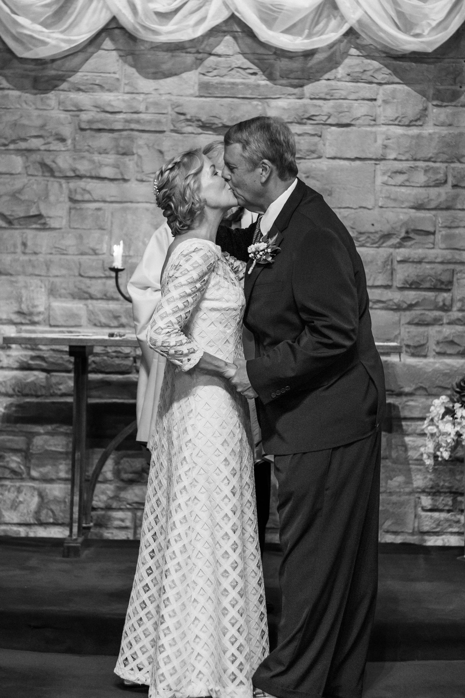 Black and white wedding ceremony photos against stone wall backdrop.