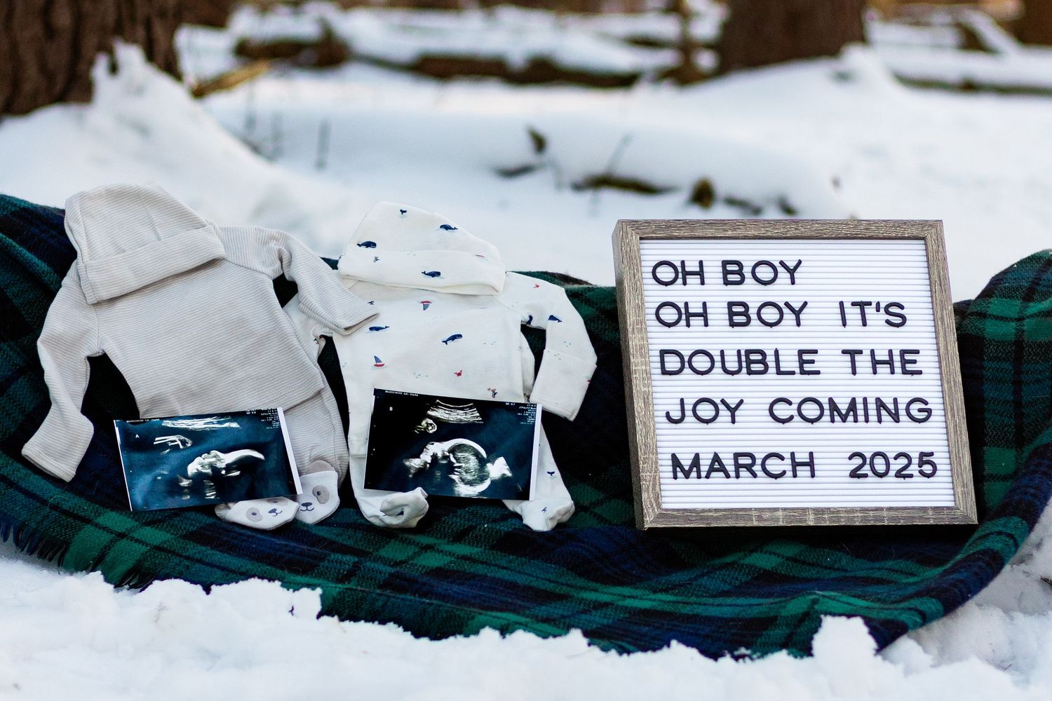 Small letter boards spelling out a pregnancy announcement against a dark background.