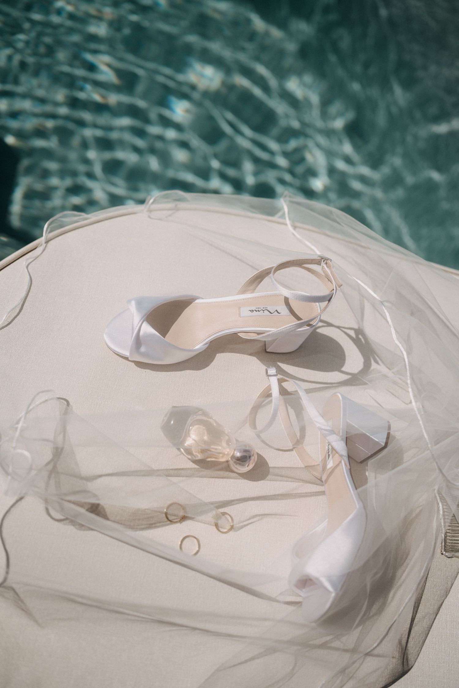 Abstract white paper art installation with curved forms and shadows against a turquoise background creates ethereal effect.