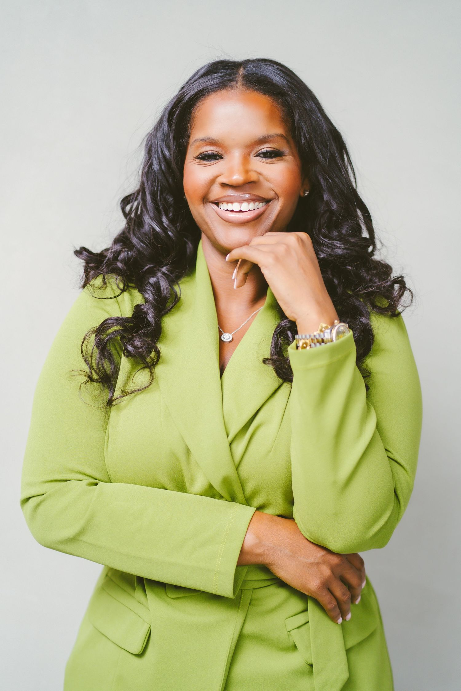 Joyful professional photoshoot showcasing a bright lime green blazer outfit.