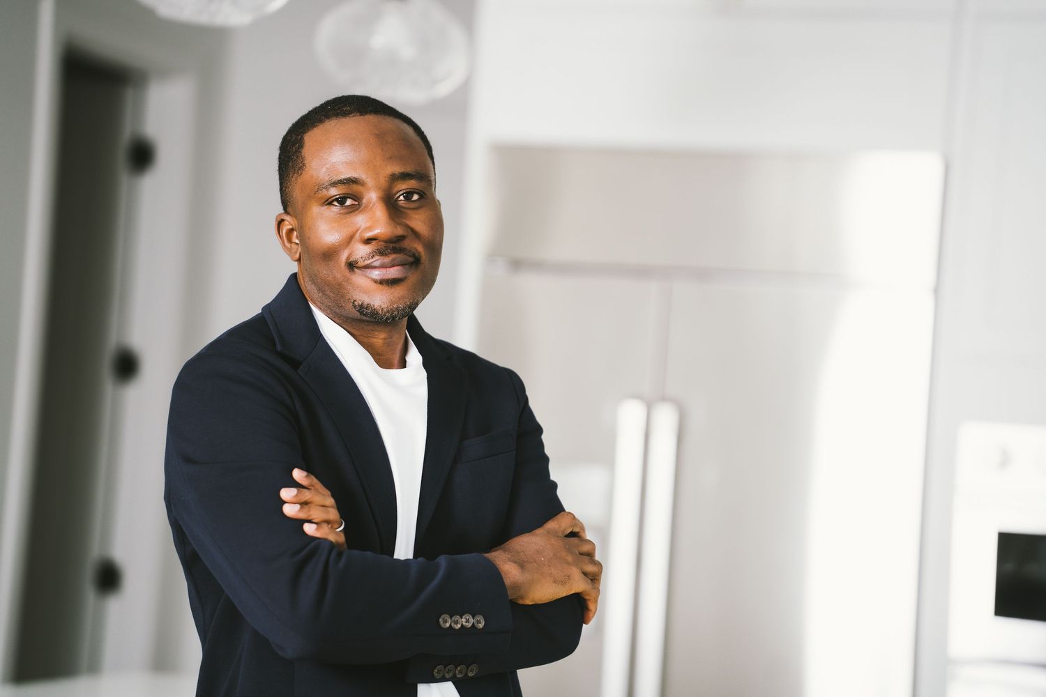 Three professional headshots showing confident expressions in a bright office environment.
