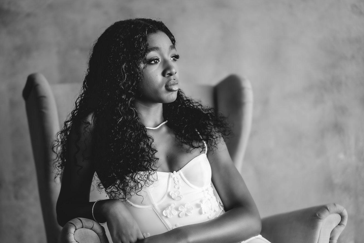 Black and white portrait series showing dynamic poses in an elegant white dress.