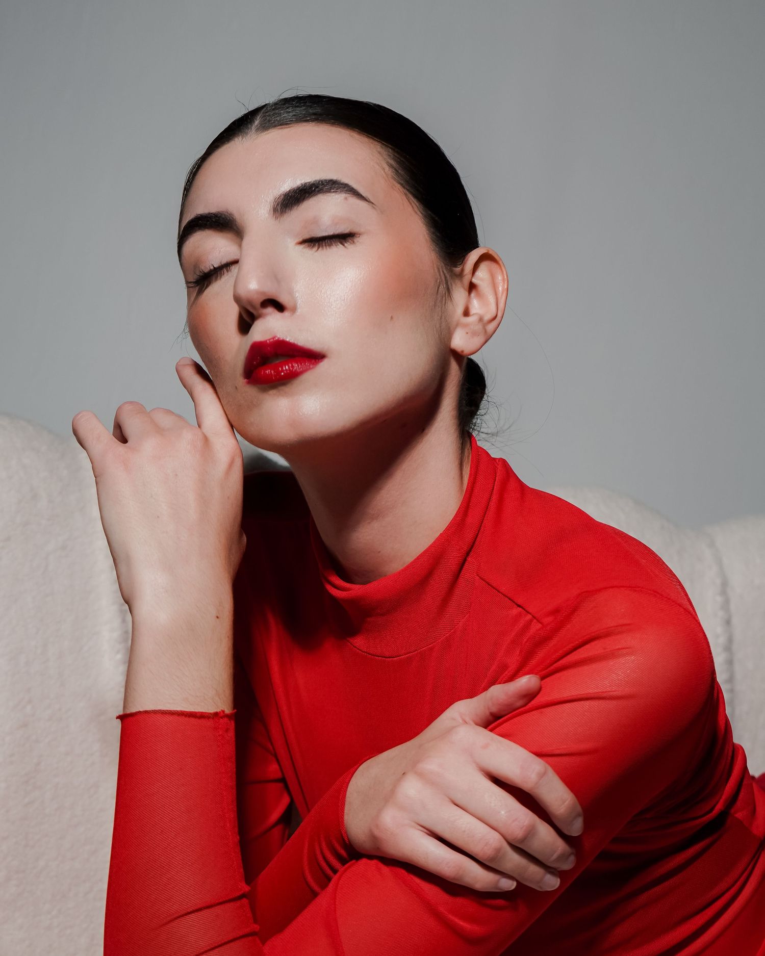 High fashion beauty portrait in red turtleneck with glamorous makeup.