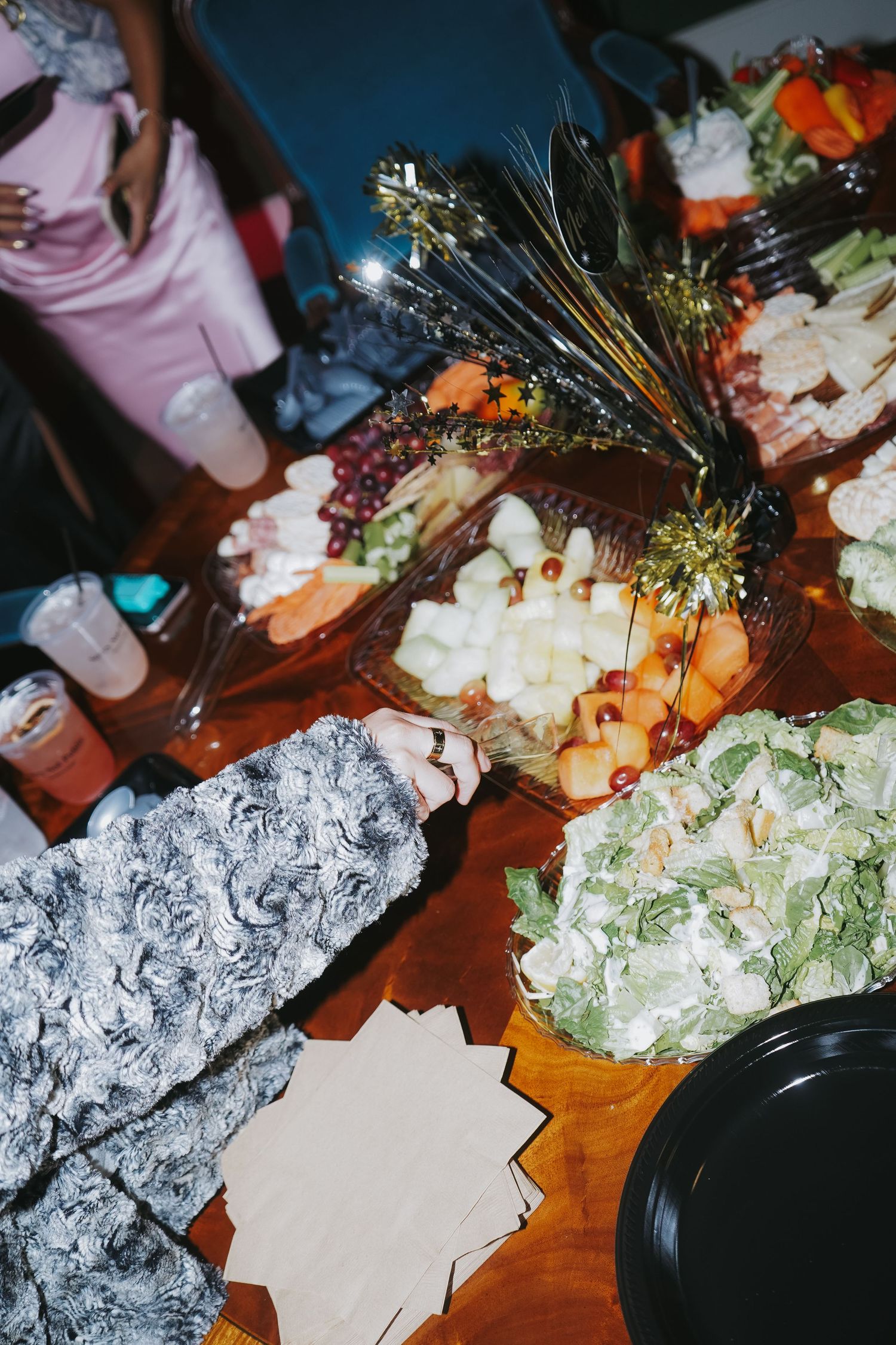 Festive party spread with decorated food platters and appetizers on a wooden table.