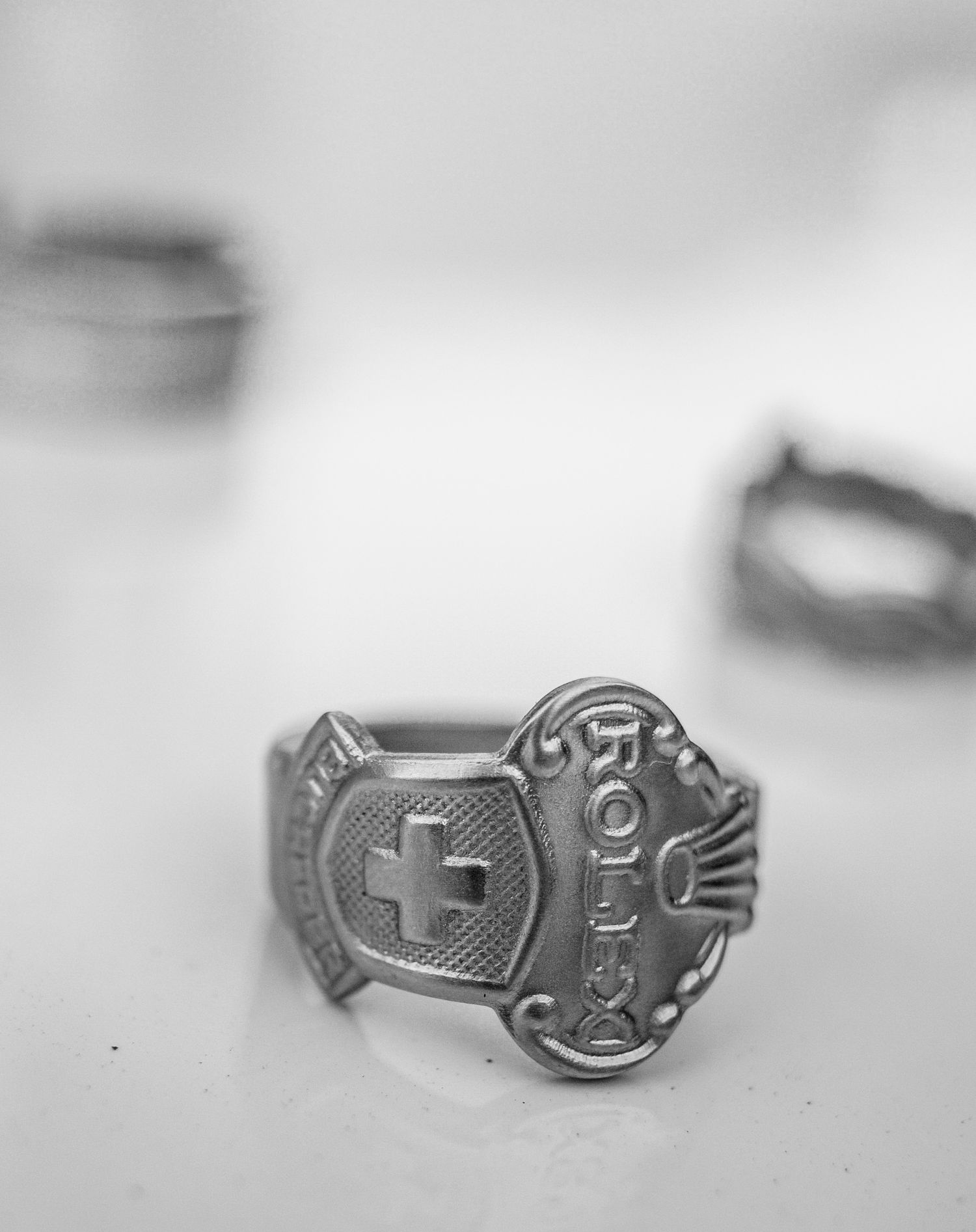 Close-up shot of a vintage Hard Rock Cafe silver ring with cross logo design.