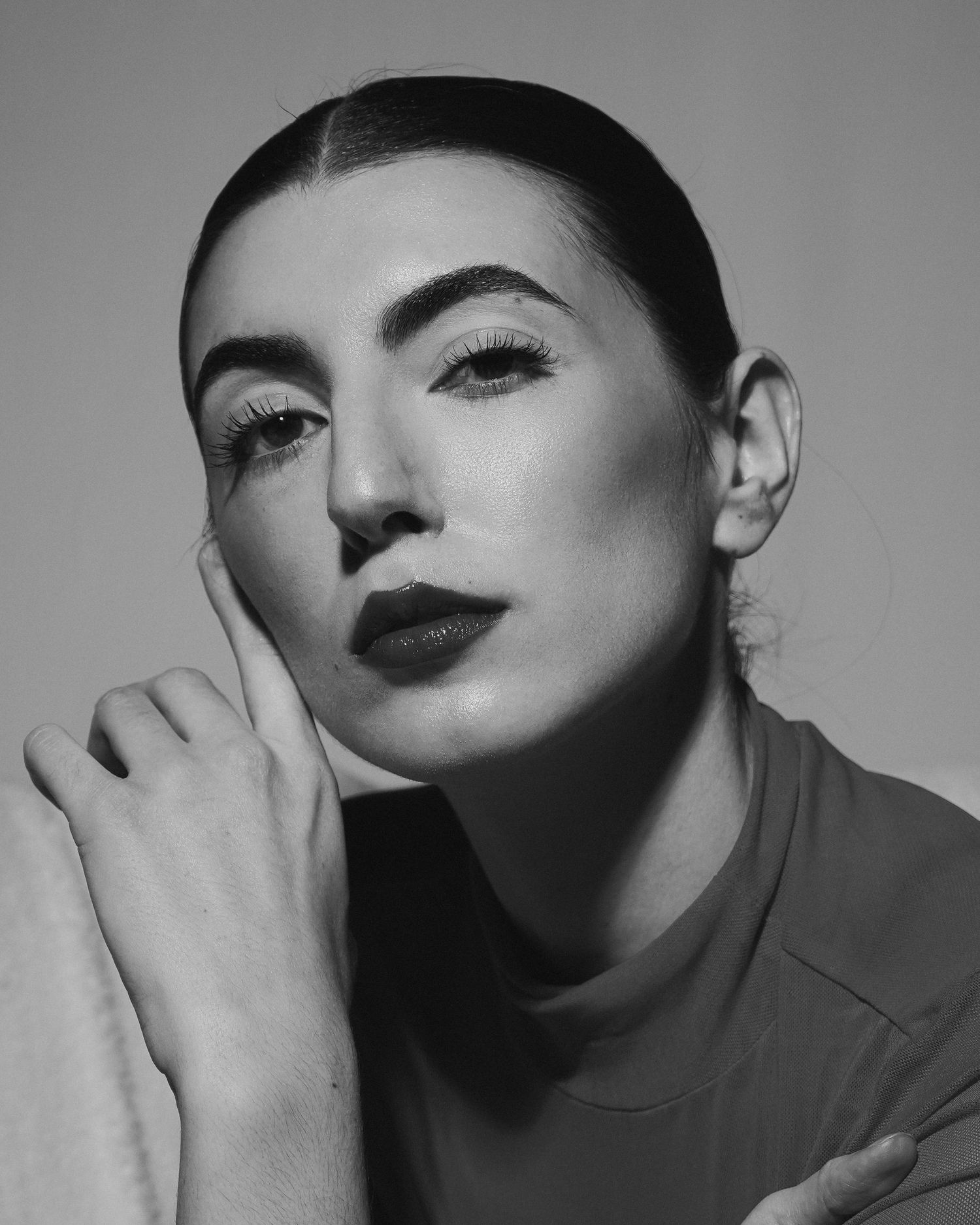 Black and white beauty portrait showcasing dramatic makeup and styling.