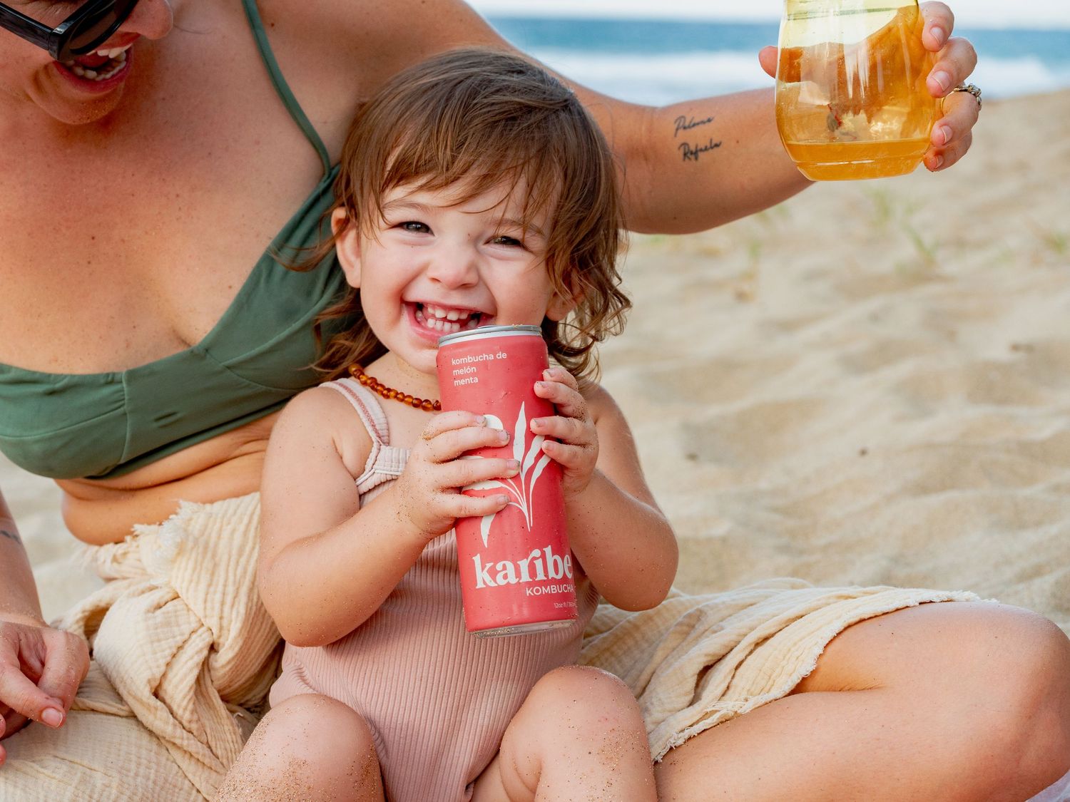 Friends enjoying refreshing drinks and snacks together on a sunny beach.