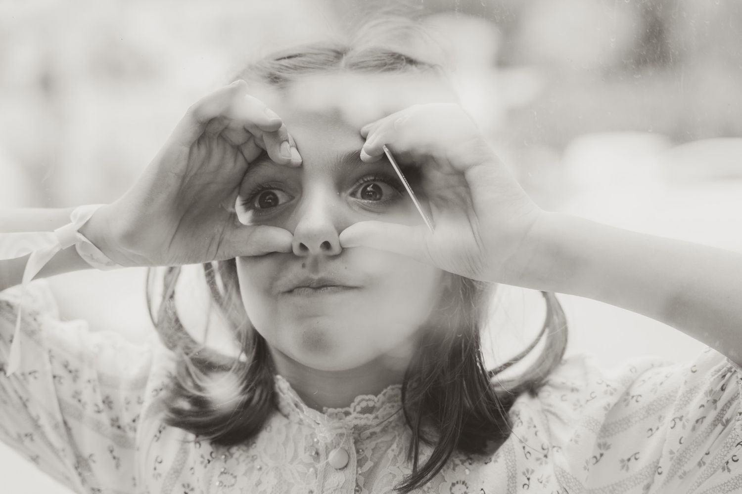 Close-up artistic black and white portrait with dreamy expression.