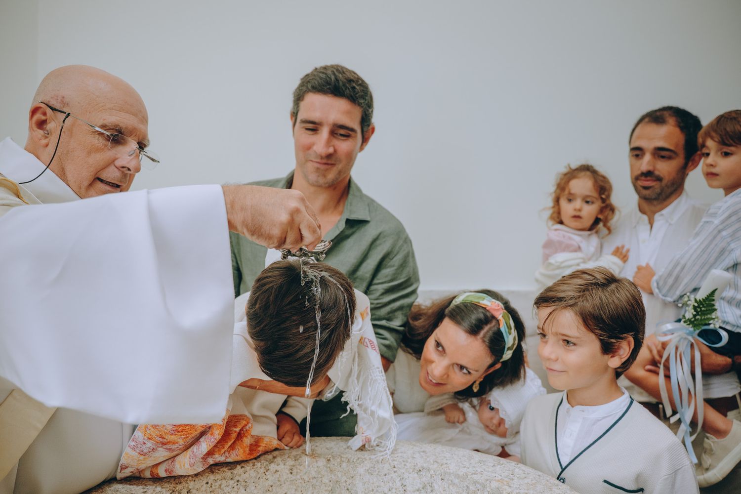 Group of people gathered around during a baptism ceremony.