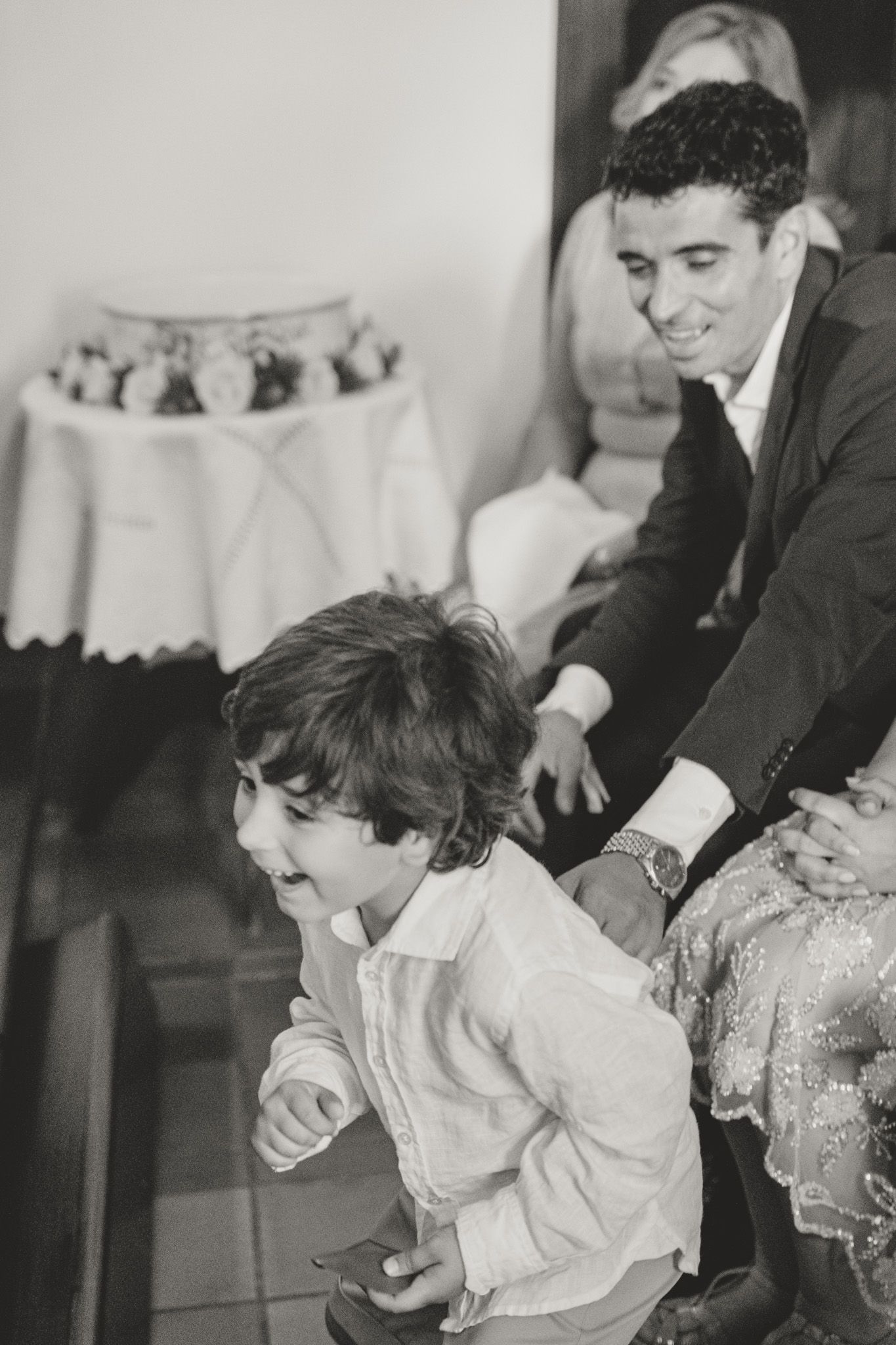 Sequence of monochrome images showing emotional moments at a baptism.