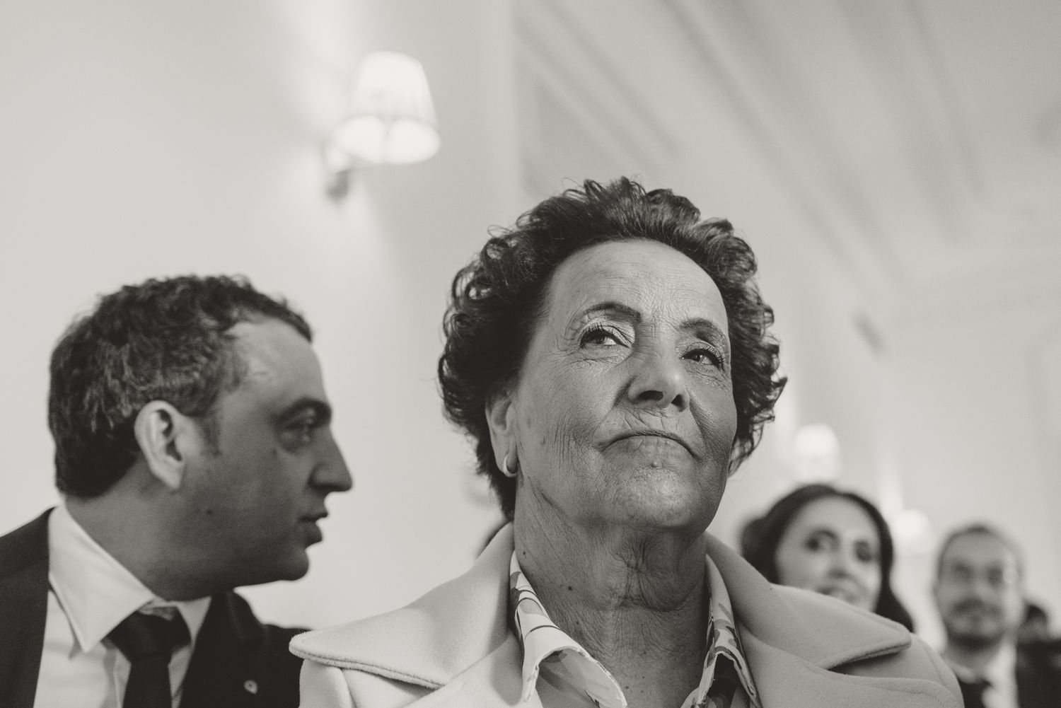 Candid black and white photographs capturing genuine reactions during wedding celebration.