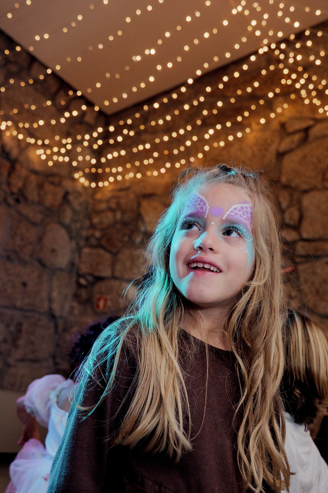 String lights create a magical ceiling above a festive celebration.