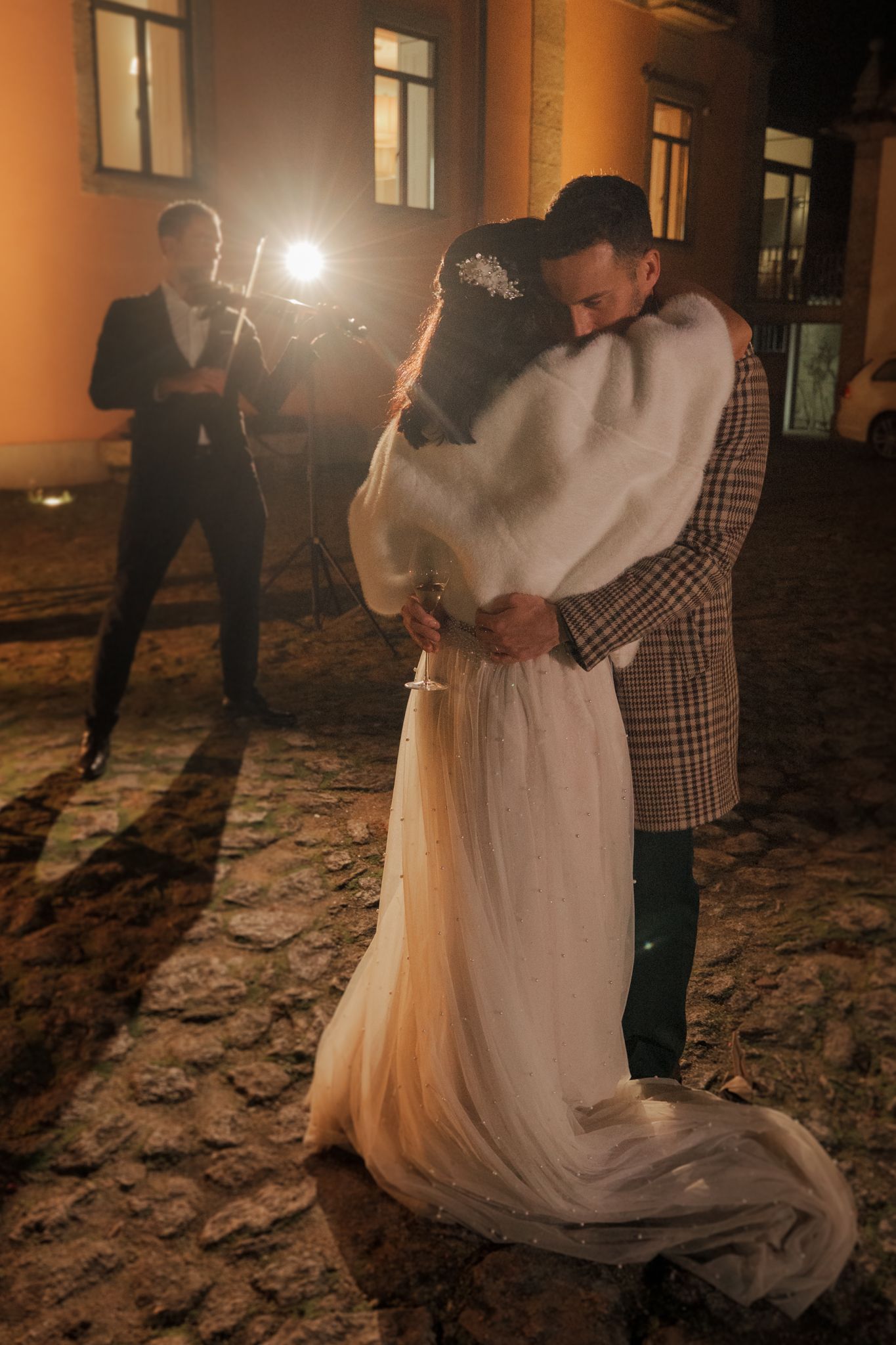 A romantic moment captured in the evening light with a couple in wedding attire.