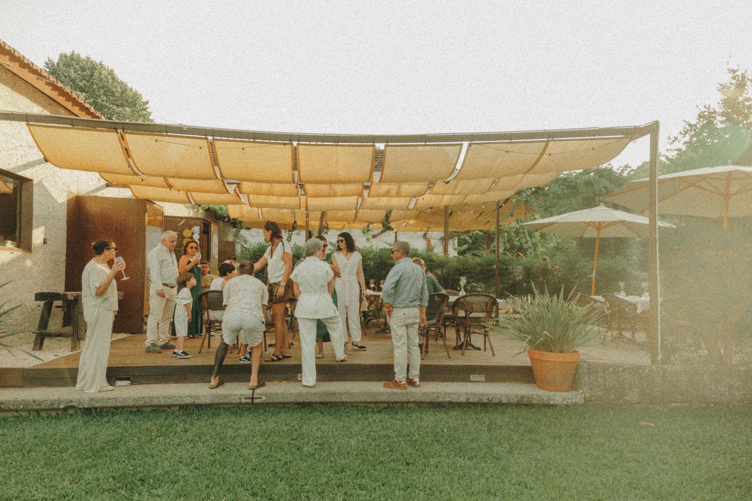 Panoramic view of an outdoor wedding venue with white canopy and natural landscape.