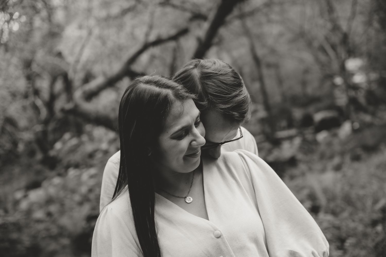 Series of romantic black and white photographs captured in a forest setting.