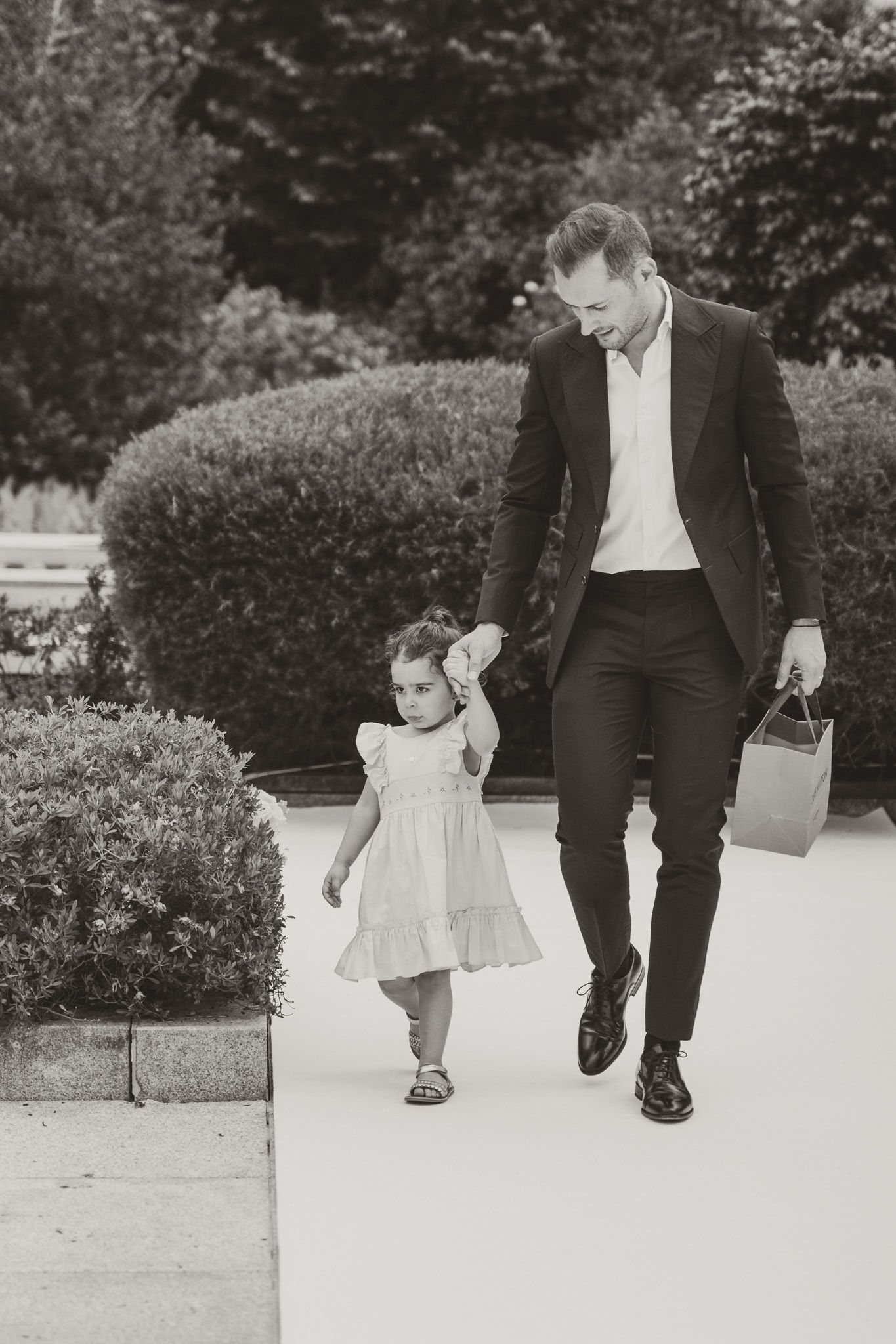 Black and white photos capturing walking moments on a garden path.