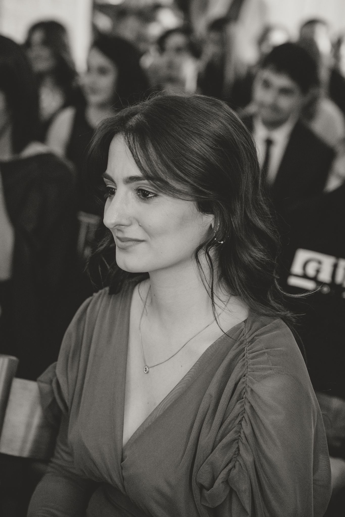 A series of black and white photos showing a bride in a white dress looking to the side with an elegant hairstyle.