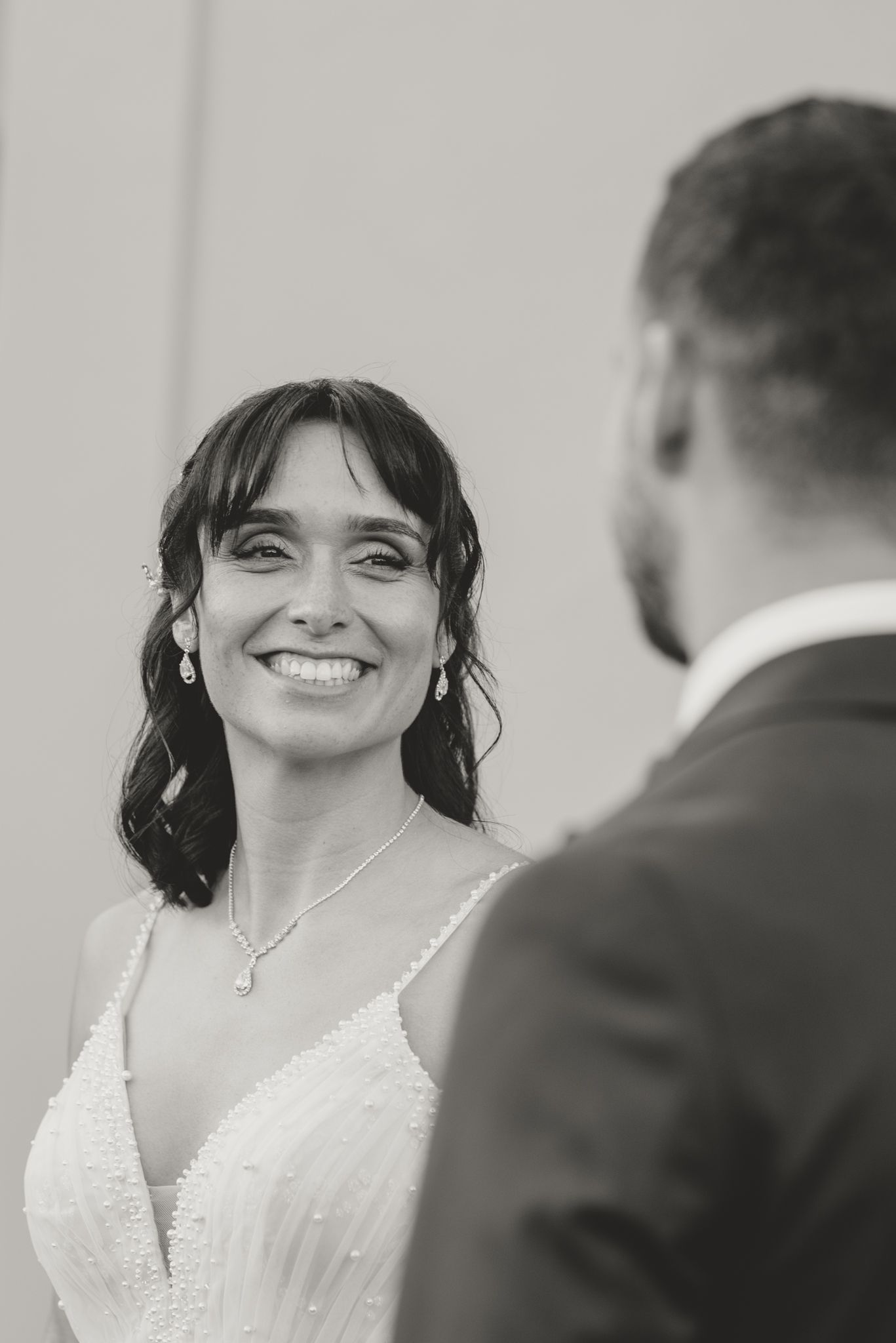 Close-up wedding portrait showing joyful expressions during intimate moment.