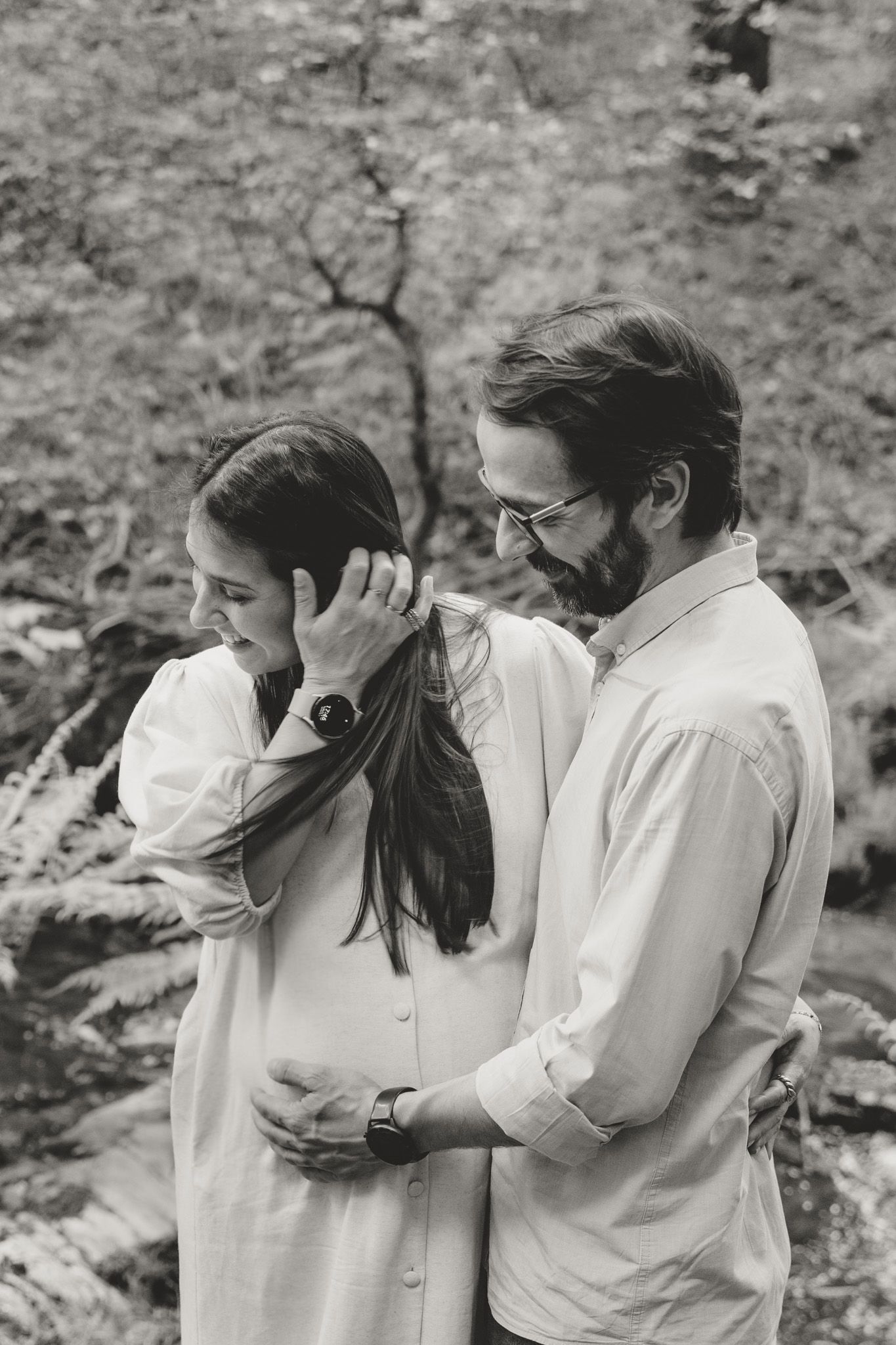 A romantic black and white photo sequence showing a couple sharing intimate moments in nature.