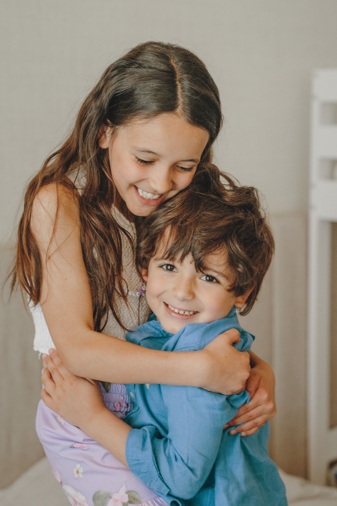 Children sharing affectionate moments on a couch in a series of candid shots.