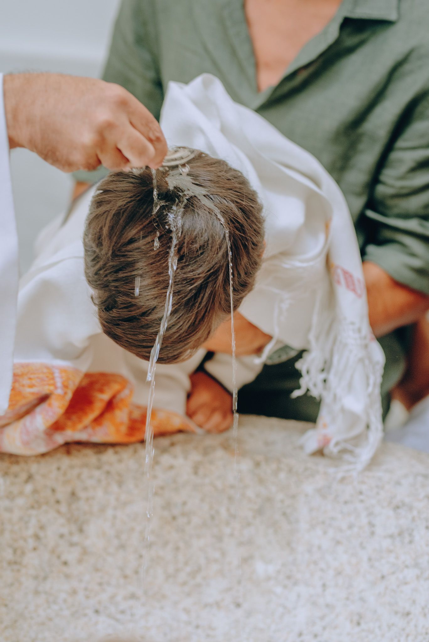 Close-up sequence showing someone pulling a string from a carpet or rug.