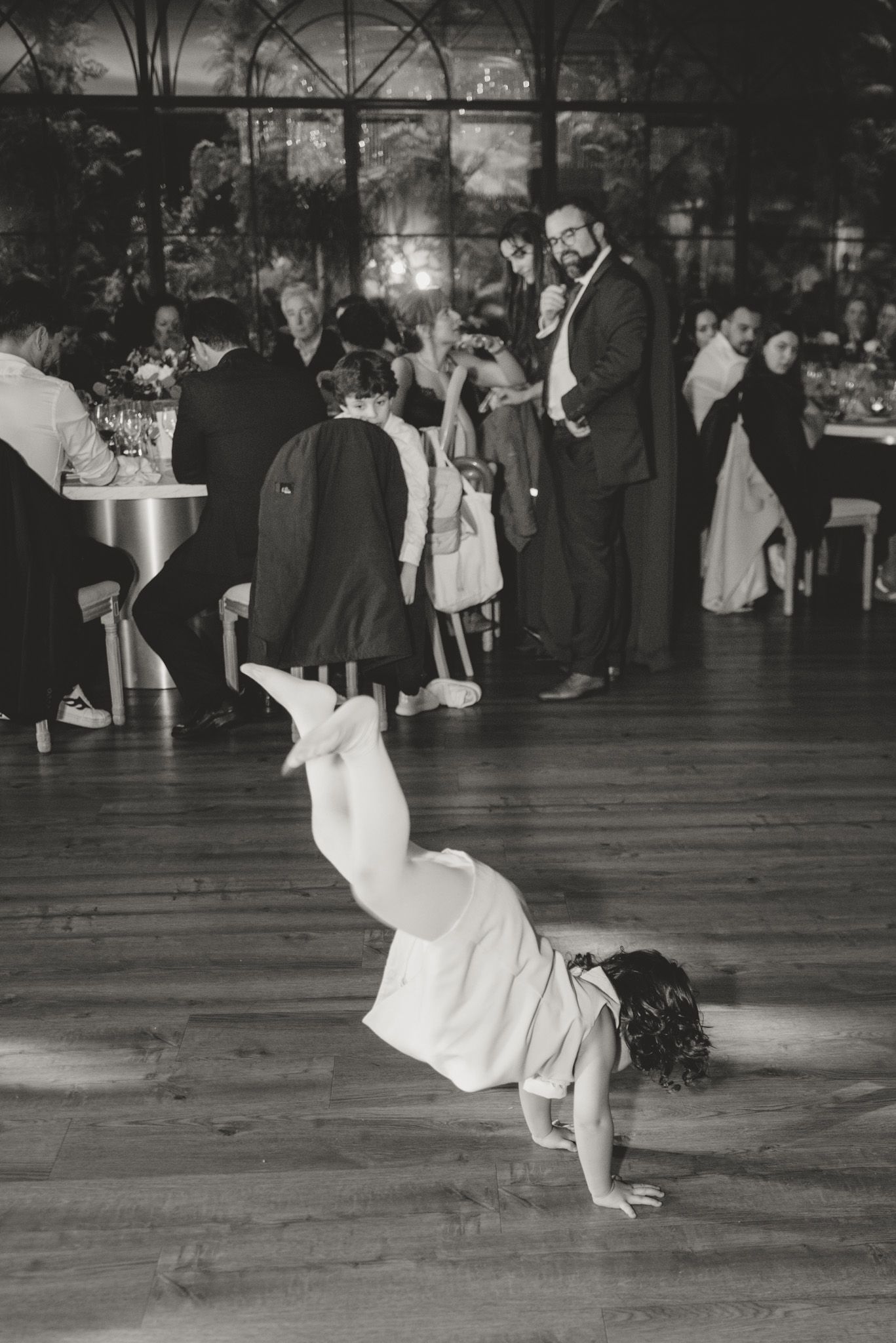 Black and white sequence showing dramatic dance dip on wooden ballroom floor.