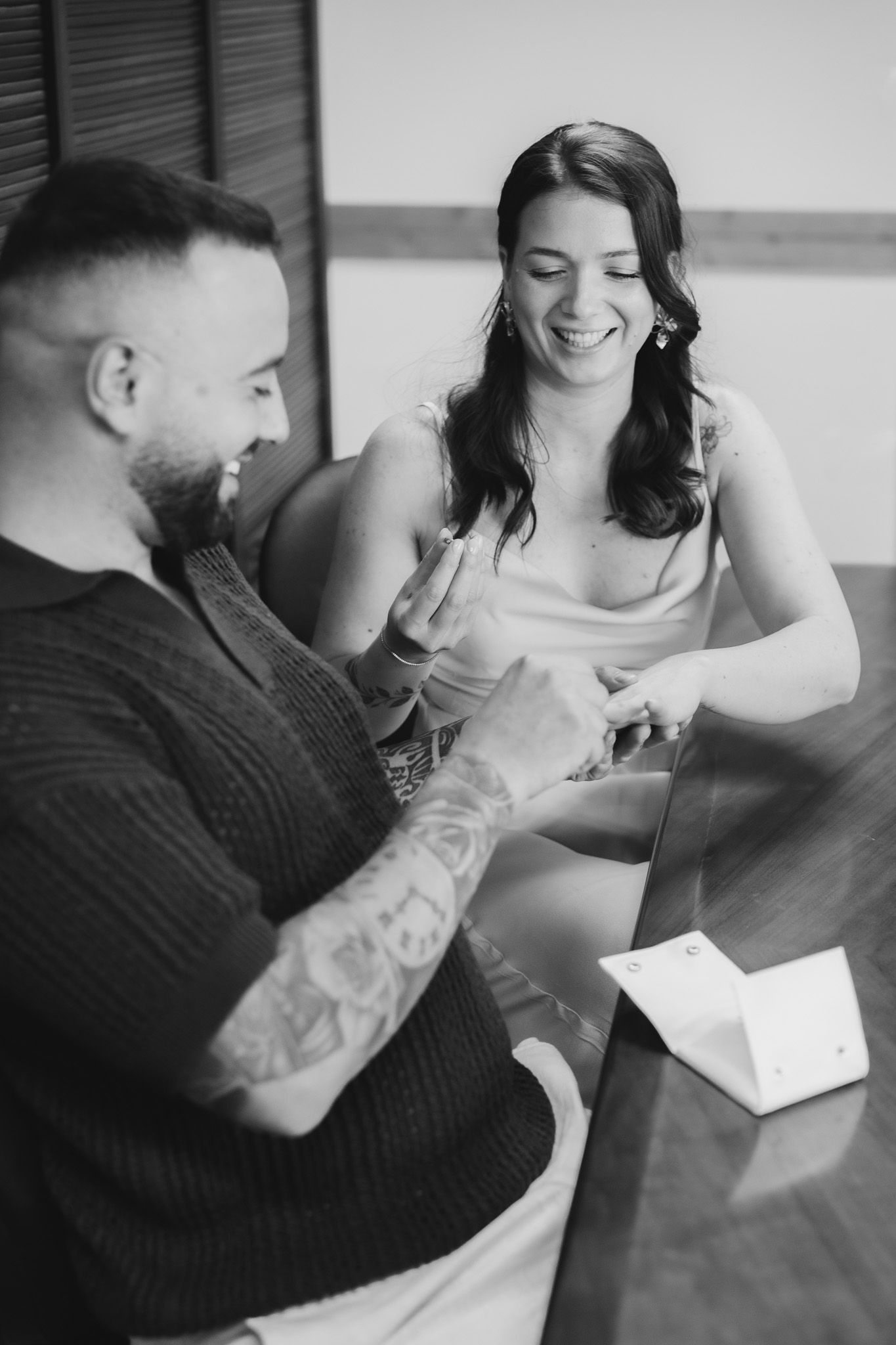 Candid black and white shots of a couple sharing a lighthearted moment together.