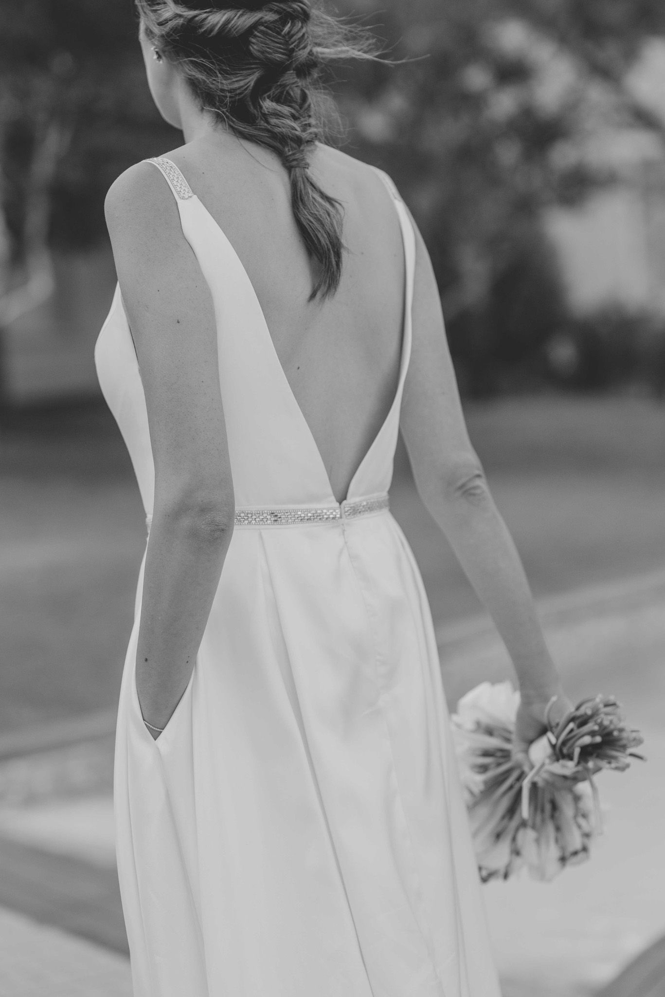 Back detail of white wedding dress showing elegant V-cut design and waistline.