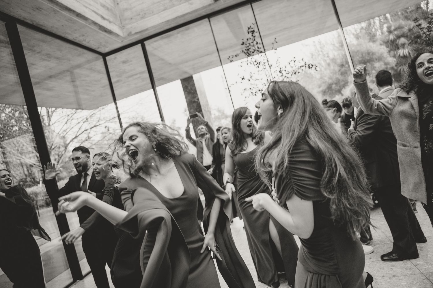 Wedding party members dance and celebrate together in a candid sequence of moments.