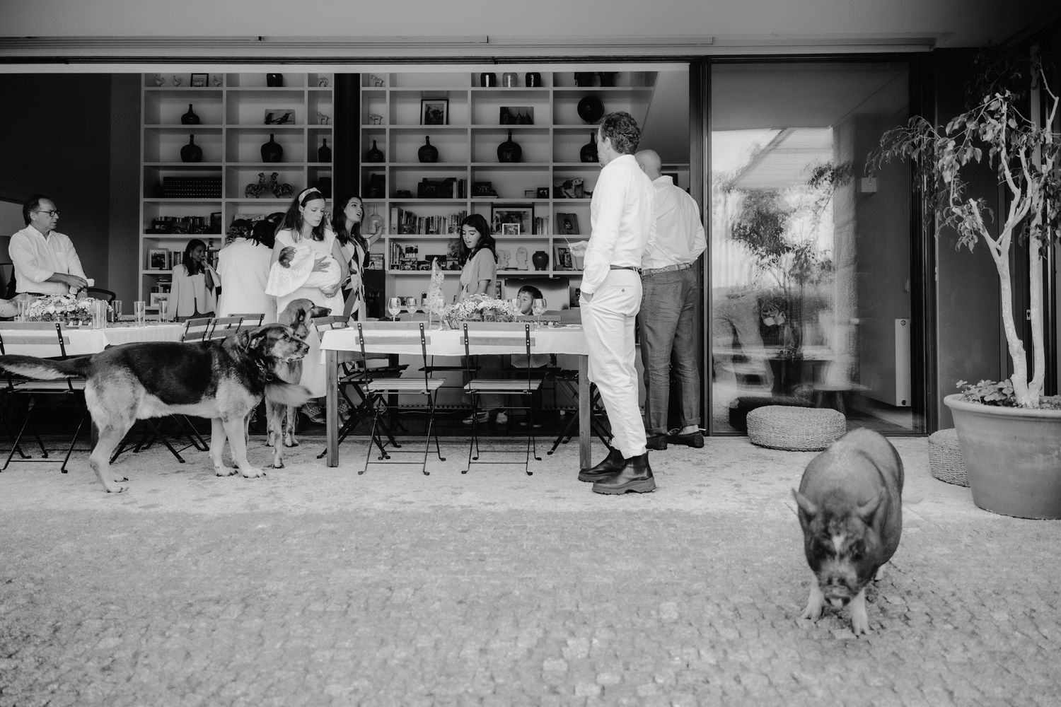 Black and white panoramic view of people outside storefronts.