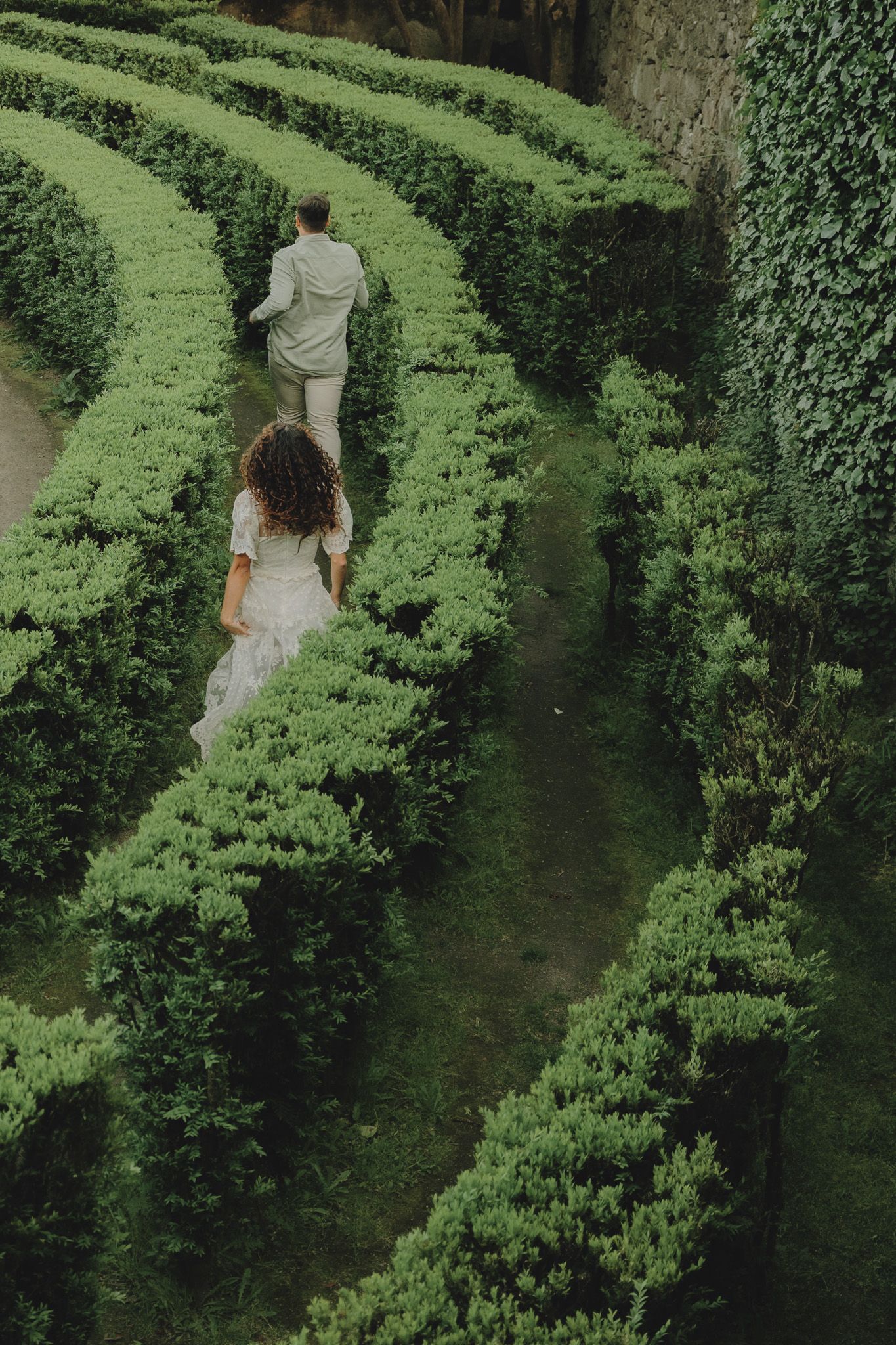 Winding paths through perfectly maintained topiary gardens create mesmerizing patterns.